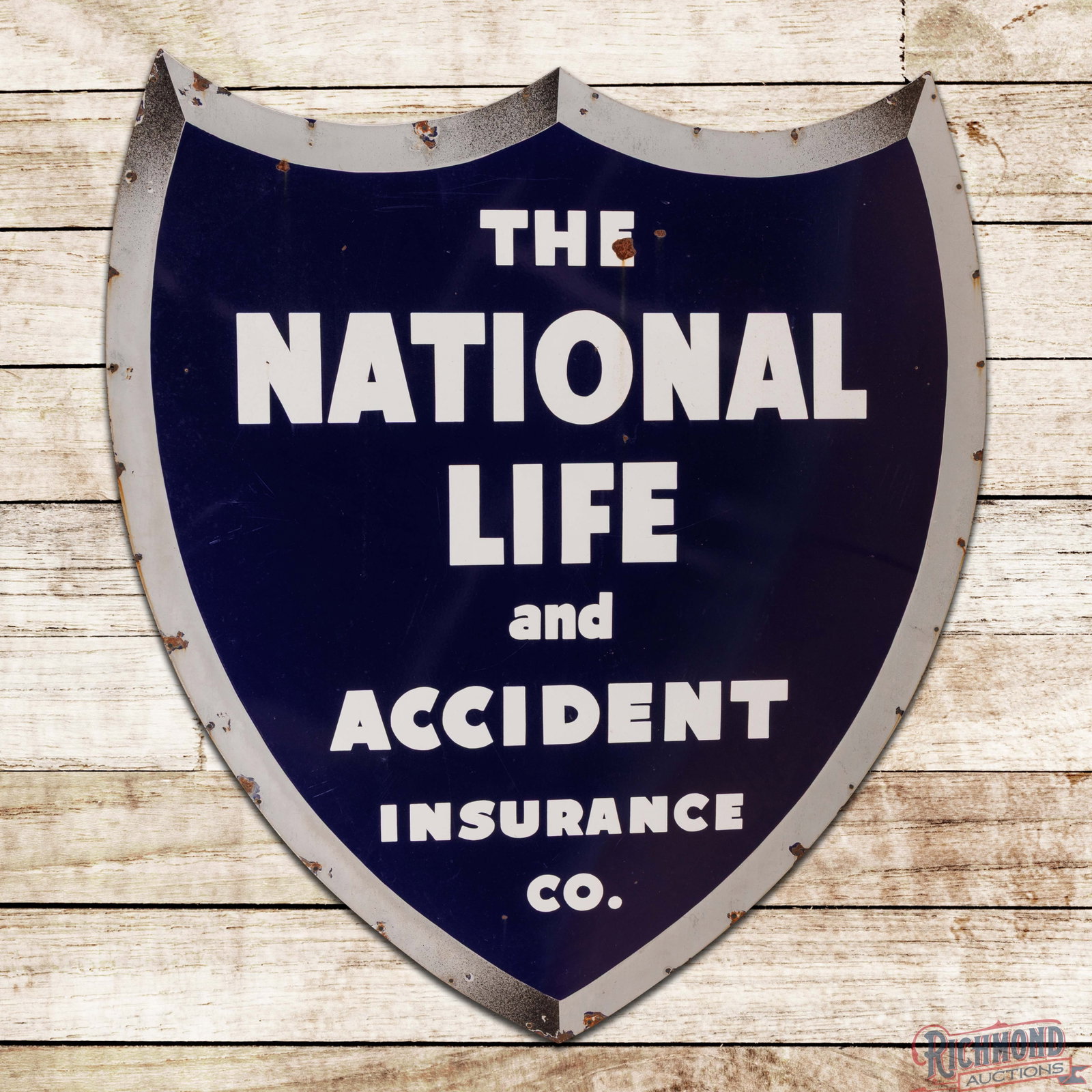 The National Life and Accident Insurance Co. 5' Single Sided Porcelain Shield Sign: SSP (single sided porcelain) die cut sign has excellent color and gloss. The display has chips with light wear and minor discoloration. The perimeter has chips at the mounting holes with areas of lowe