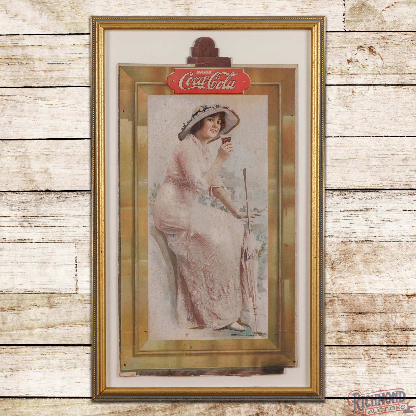 Drink Coca Cola Elaine SS Die Cut Cardboard Advertising Display Sign Framed: Single sided die cut cardboard sign has been framed under glass. The sign features a detailed graphic of Elaine holding a glass of Coca Cola. The field has spotting with areas of surface wear and fadi