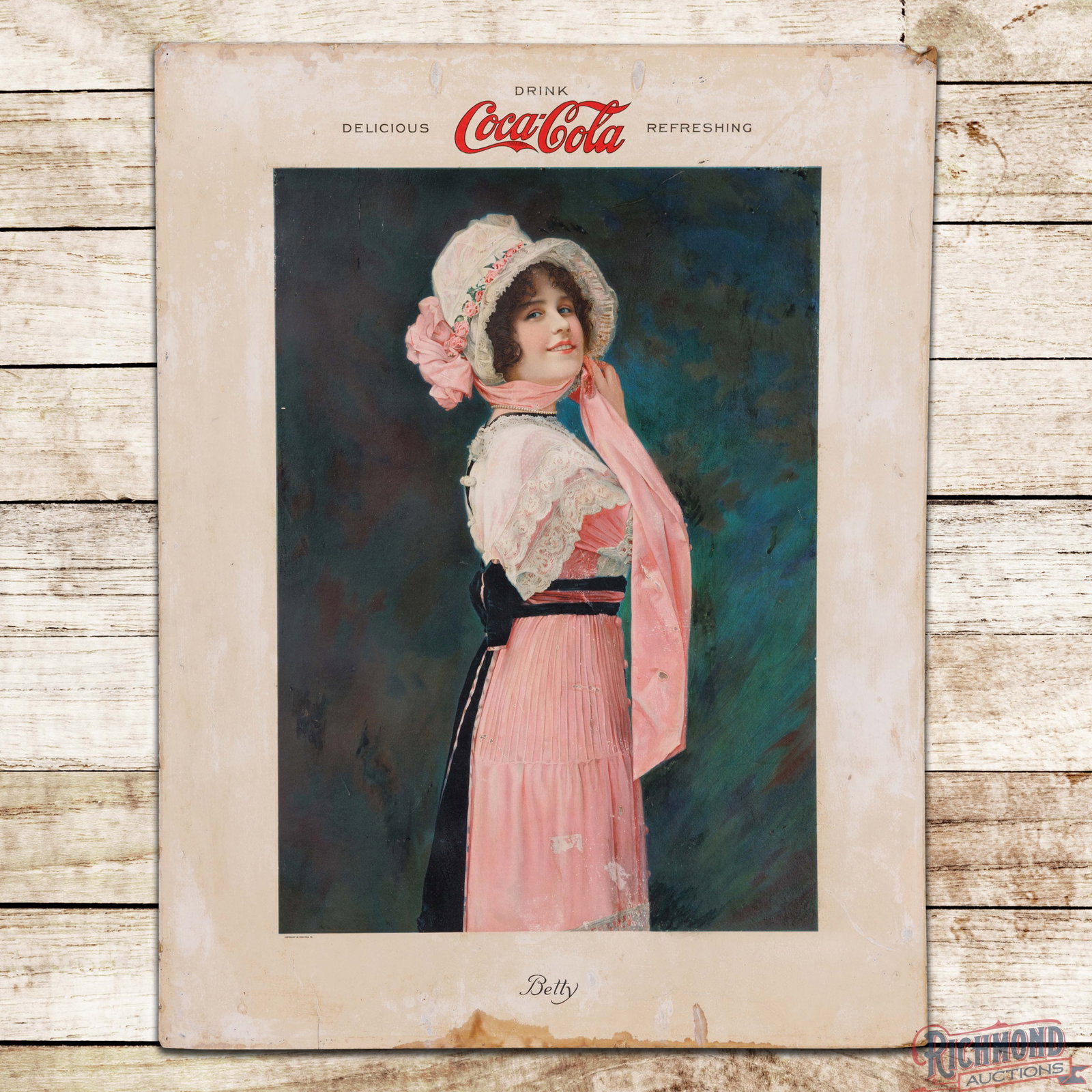 Drink Coca Cola Delicious Refreshing SS Cardboard Sign "Betty": Single sided cardboard sign has good color. The display features a colorful, highly detailed graphic of "Betty" in the center field. The field has scuffs with areas of discoloration, fine scratches an