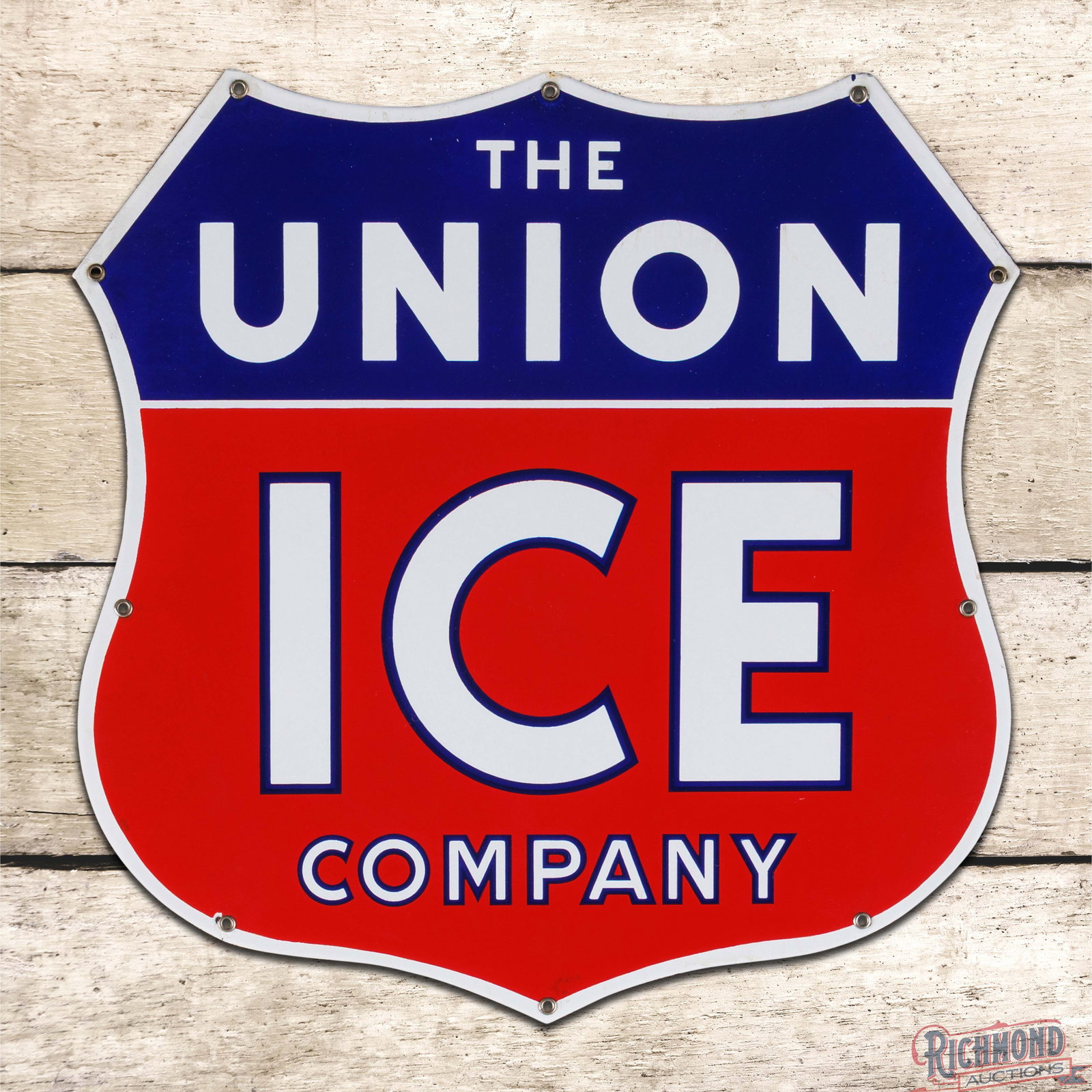 The Union Ice Company 17" Single Sided Porcelain Shield Sign: SSP (single sided porcelain) die cut sign has outstanding color and gloss. The field is clean with a few minimal surface imperfections. The perimeter has a small chip at the lower left mounting hole w