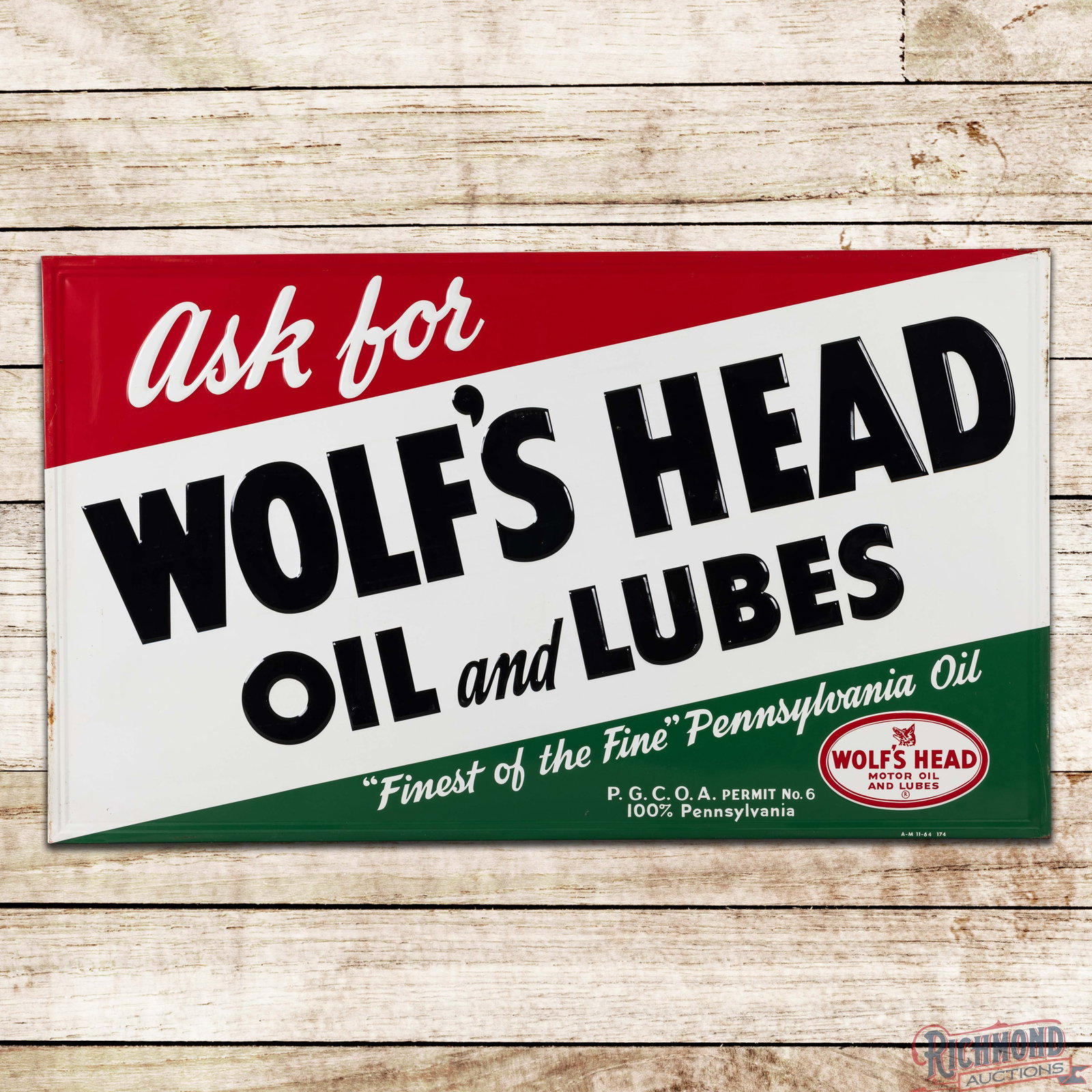 1964 Ask for Wolf's Head Motor Oil & Lube Emb. Single Sided Tin Sign w/ Logo: SST (single sided tin) embossed self-framed sign with the factory wooden support frame has excellent color and shine. The field is very clean overall with light surface wear to the embossed lettering 