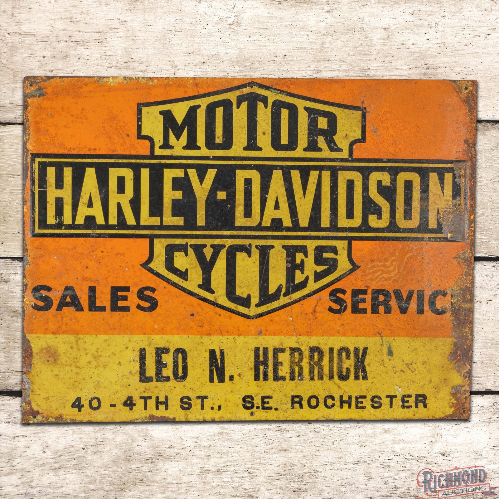 Harley Davidson Motor Cycles Sales Service Leo Herrick Rochester Single Sided Tin Sign w/ Logo: SST (single sided tin) sign has good color and shine. The display has discoloration with paint chips and fine scratches. The outer fields and perimeter have bends with larger paint chips and oxidation