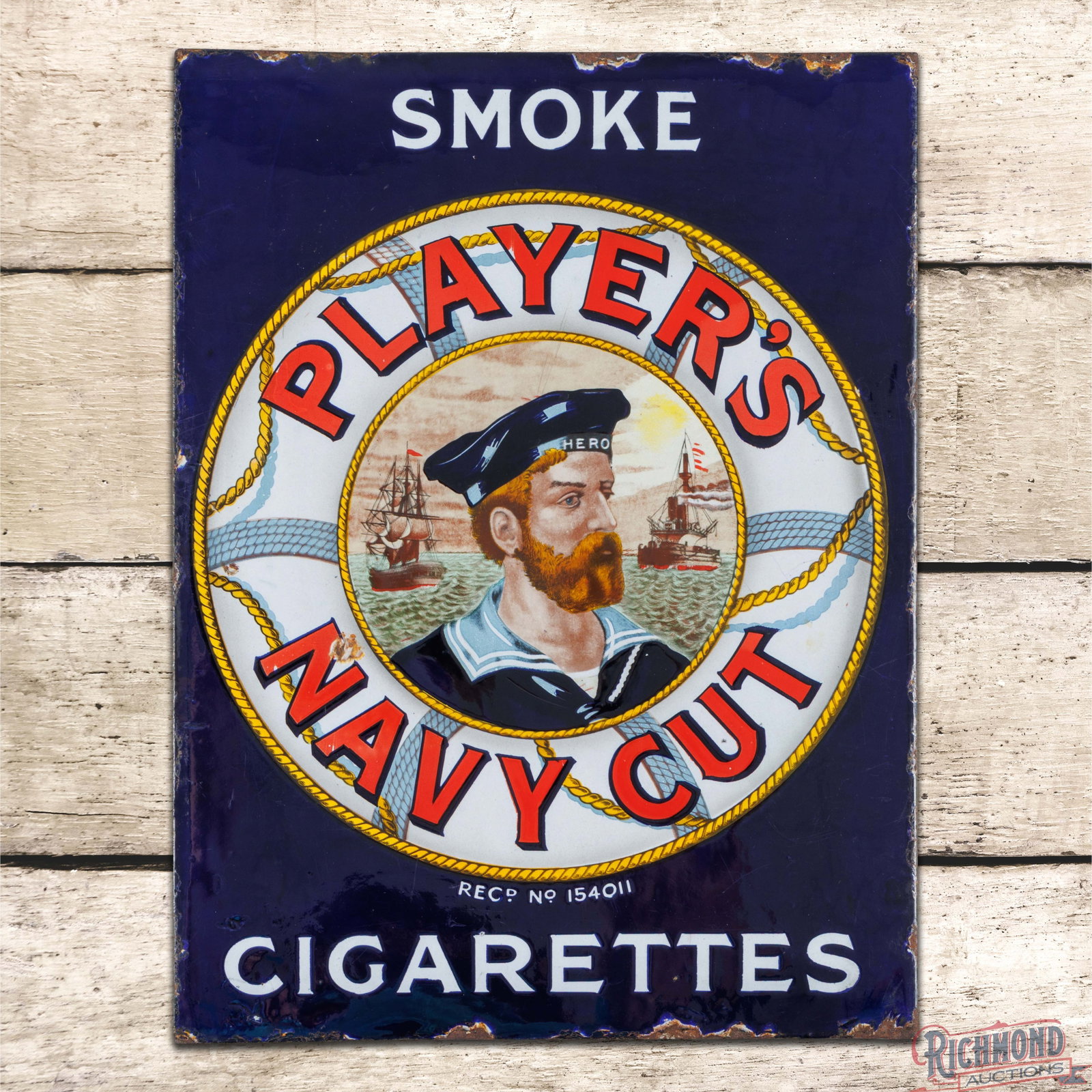 Smoke Player's Navy Cut Tobacco Double Sided Porcelain Flange Sign w/ Hero: DSP (double sided porcelain) flange has excellent color and gloss. Side #1 has light surface wear with a tiny flea bite in the "T" of Cut in the lower field. The perimeter has small chips along the ou