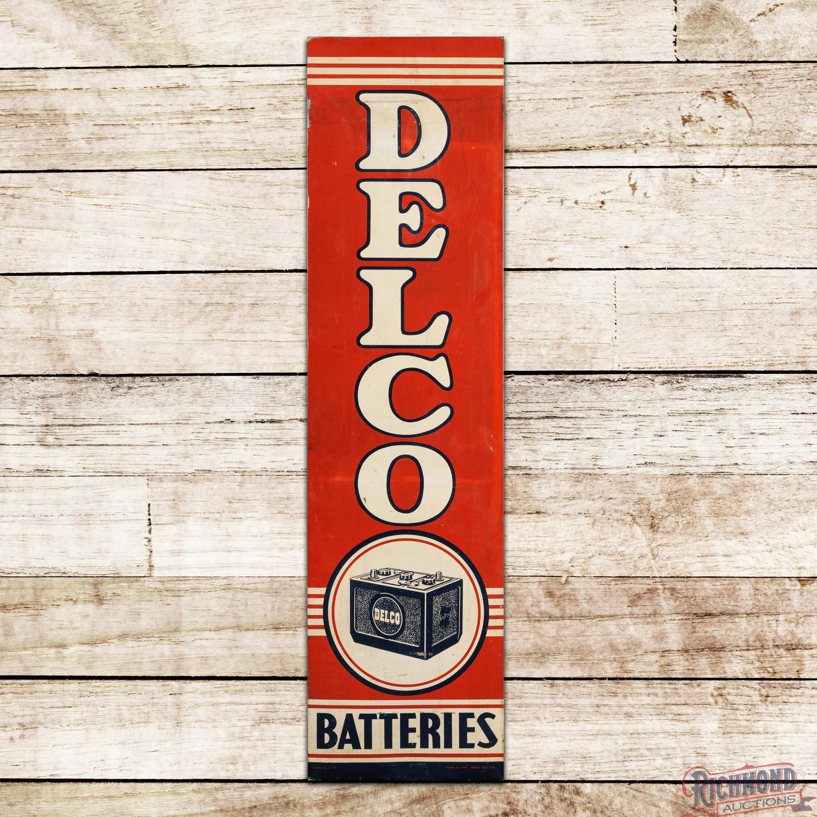 1949 Delco Batteries Vertical 6' Single Sided Tin Sign: SST (single sided tin) sign with the factory wooden frame has good color and shine. The display has toning throughout with fine scratches and areas of discoloration. The lower fields have surface rubs