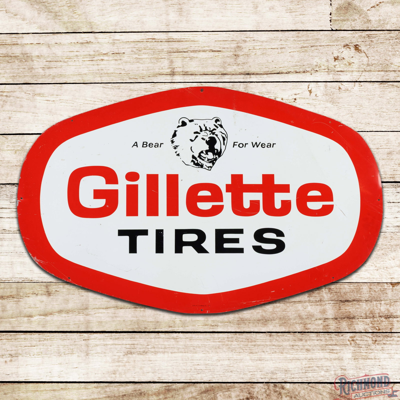 1975 Gillette Tires "A Bear for Wear" 4' Single Sided Tin Sign: SST (single sided tin) die cut sign has very good color and shine. The field has small paint chips, scratches, small indentations and areas of minor oxidation. The perimeter has small edge bends with 