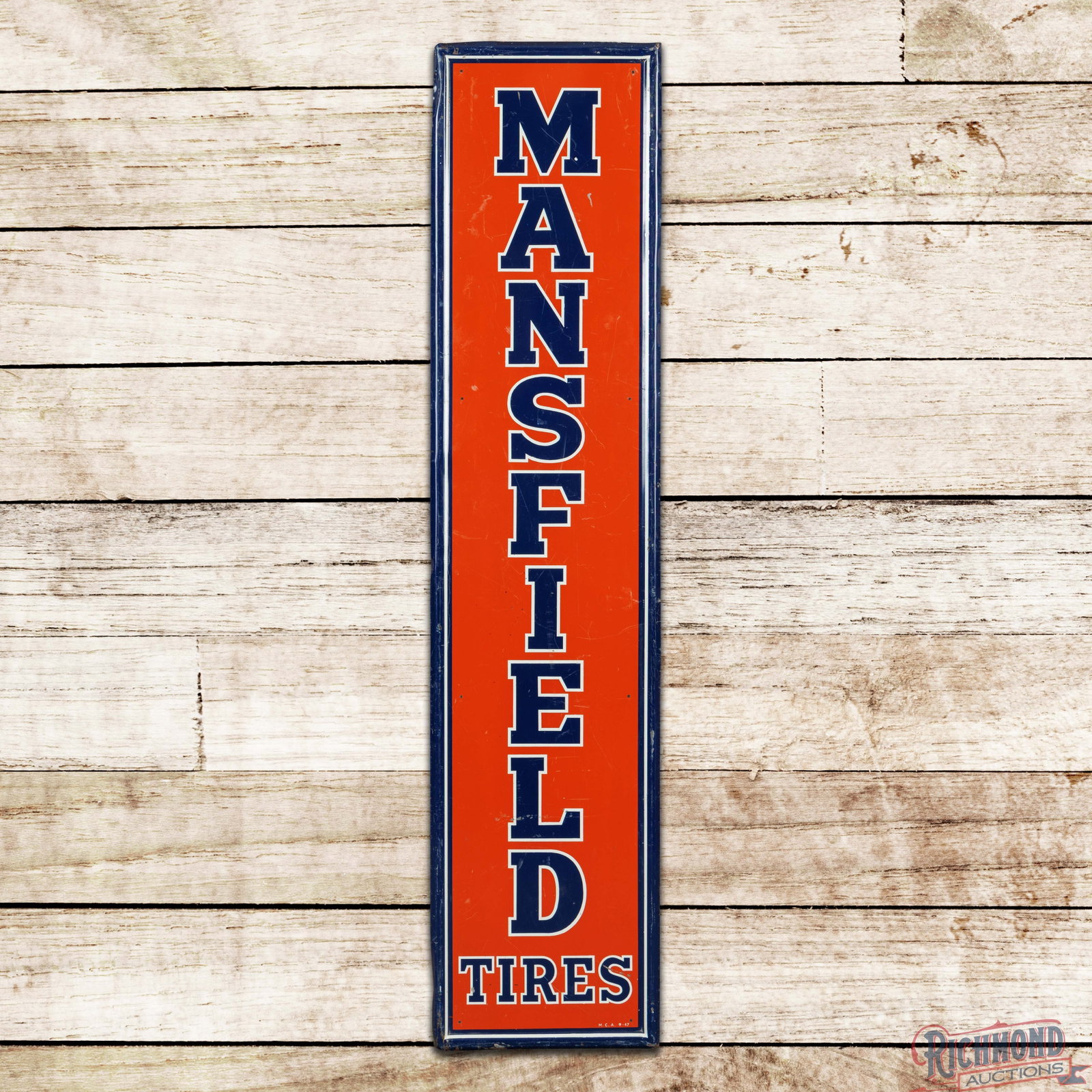 1947 Mansfield Tires 5' Vertical Single Sided Tin Sign: SST (single sided tin) self-framed sign has very good color and shine. The display has fine scratches with paint chips and minor spotting in the lower left field. The perimeter has general wear to the