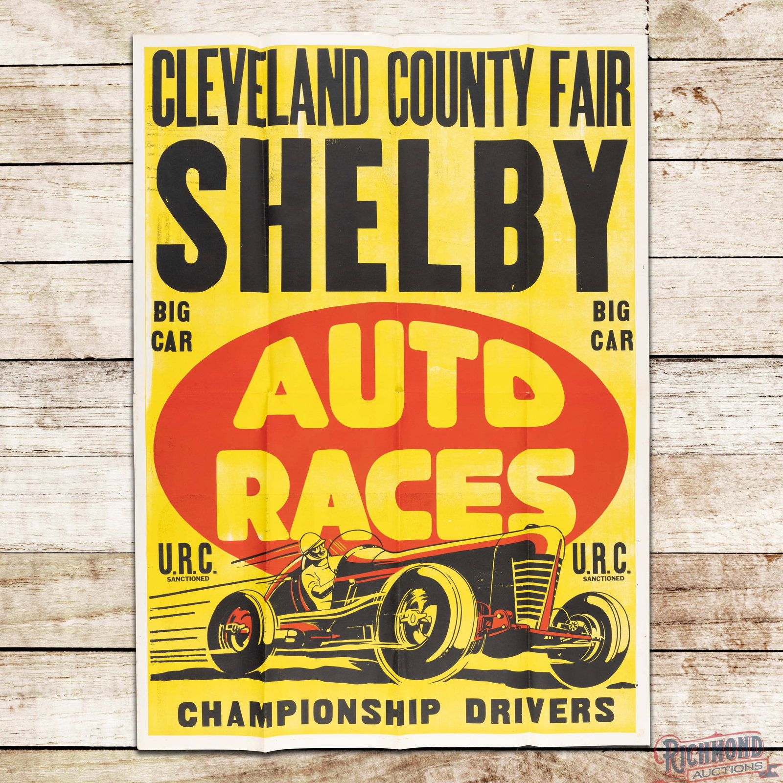Cleveland County Fair Auto Races U.R.C. Sanctioned Championship Drivers Advertising Poster: Single sided advertising poster has very good color. The poster exhibits fold marks with areas of discoloration and small tears at the folds. The outer fields and perimeter have similar wear. Overall 