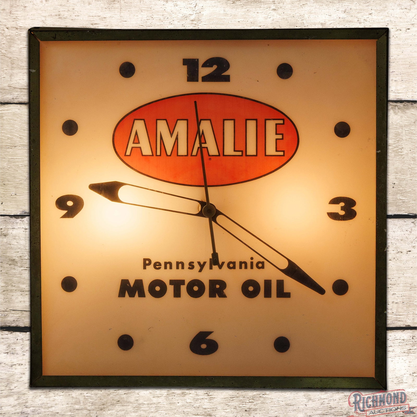 Amalie Pennsylvania Motor Oil 15" Lighted Advertising Clock: Lighted advertising clock works properly. The inner face has slight fading throughout with wash to the red in the logo. The metal can trim ring has minor bends and the can retains the original paint. 