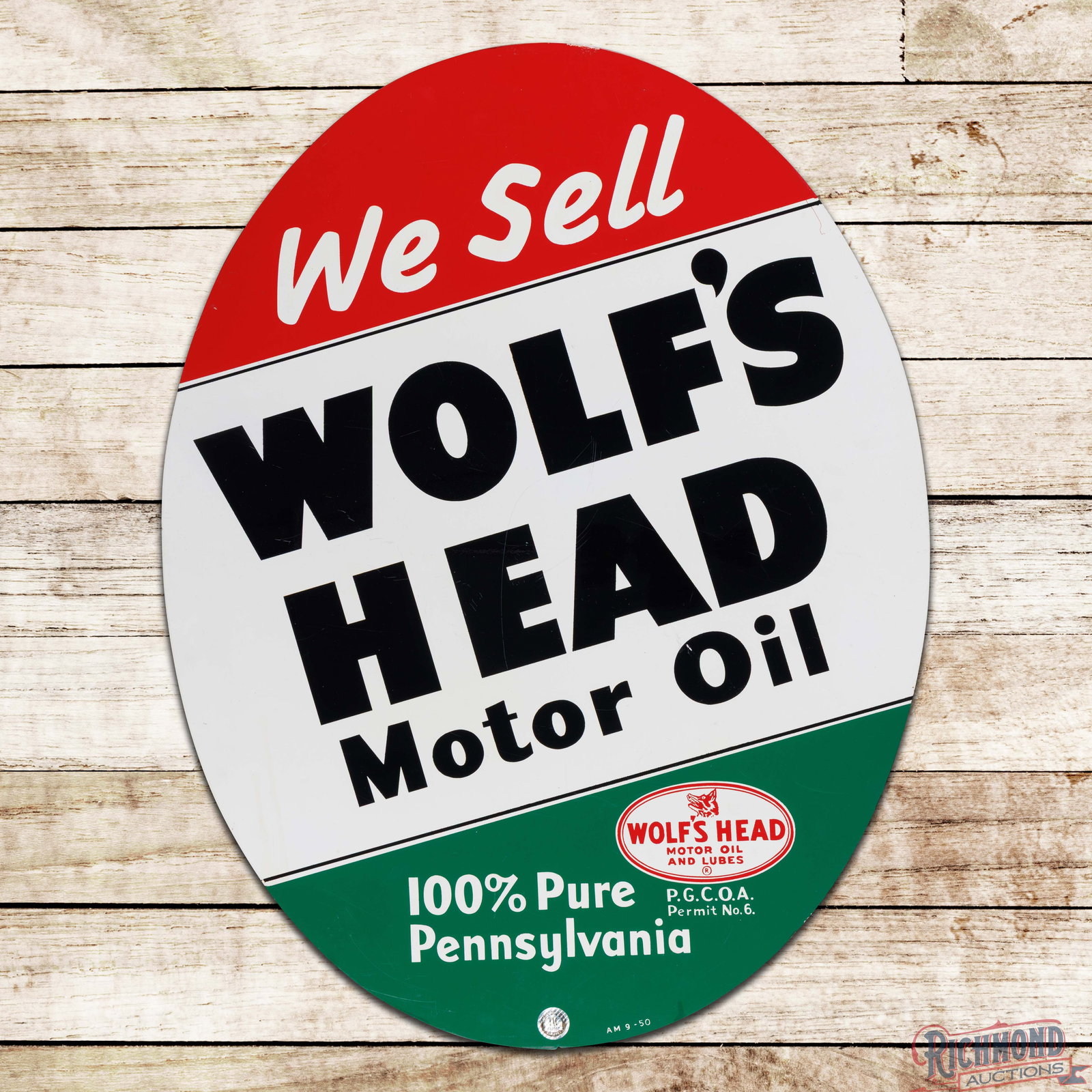 1950 We Sell Wolf's Head Motor Oil w/ Logo: DST (double sided tin) sign has excellent color and shine. The display has fine scratches and small paint chips in the "F" of Wolf's. The perimeter has small scuffs with a handful of tiny paint chips.