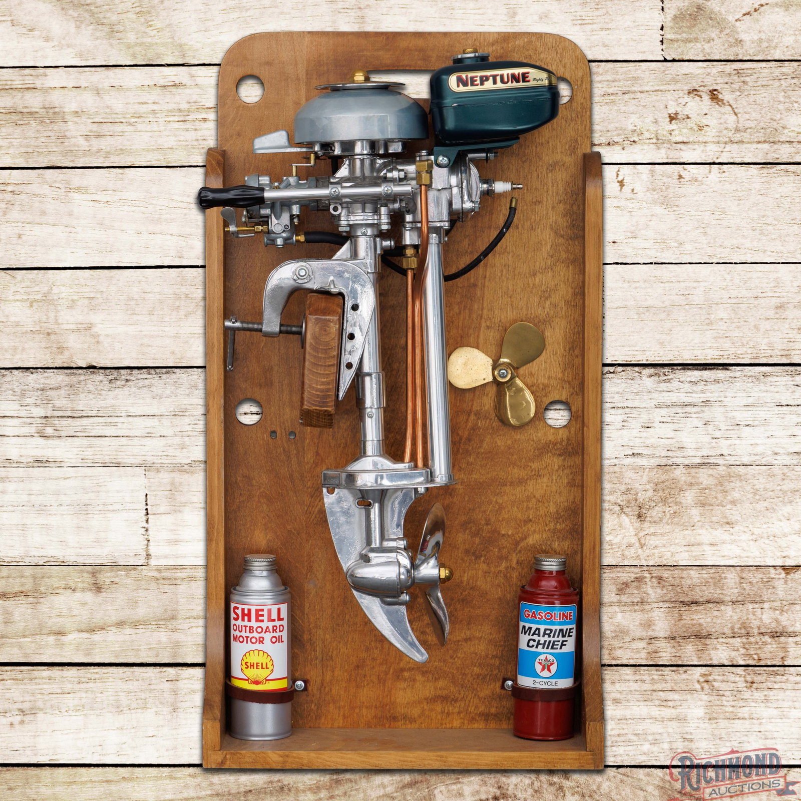 Neptune Mighty Mite Outboard Engine Display: Neptune Mighty Mite engine has been professionally restored and mounted to a custom wood display. The display is clean and features a propeller and a custom Shell Outboard Motor Oil can and a Texaco M