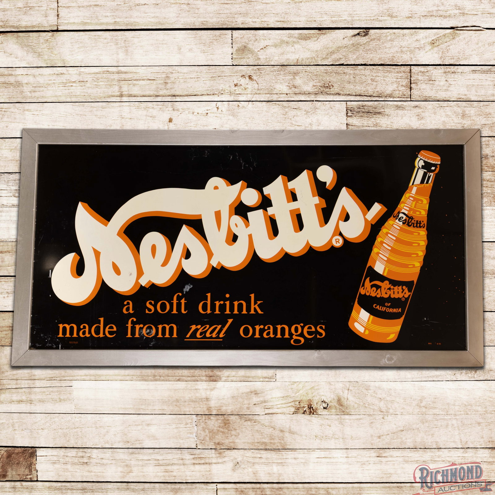 Nesbitt's of California "Made from Real Oranges" 8' Single Sided Tin Sign w/ Bottle: SST (single sided tin) sign with an added wooden frame has very good color and shine. The field has scuffs with fine scratches and light wear. The outer fields and perimeter have additional scratches 