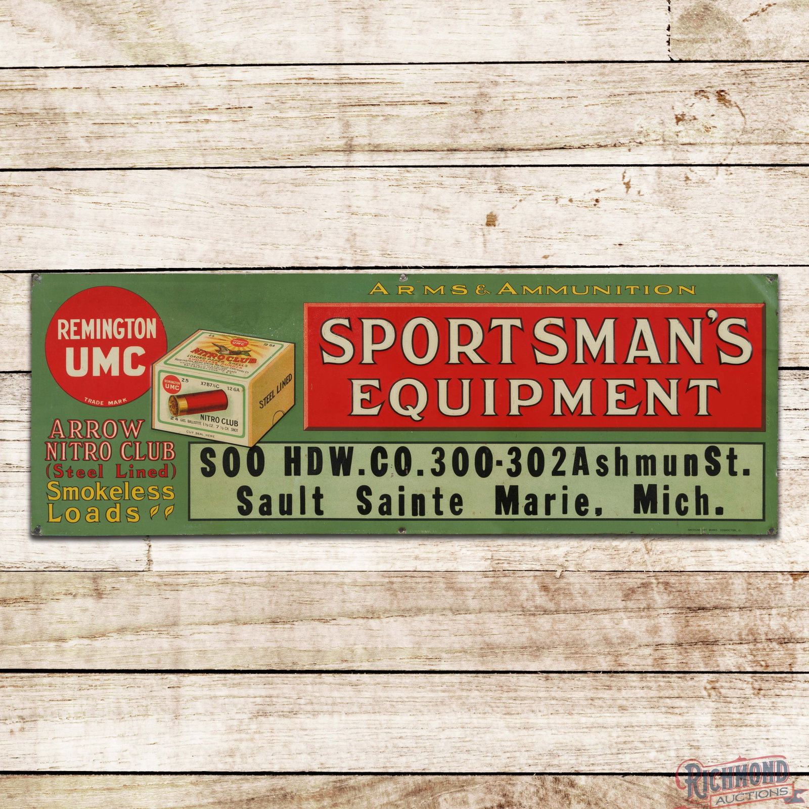 Remington UMC Arms & Ammunition Sportsman's Equipment Emb. Single Sided Tin Sign Marie Michigan: SST (single sided tin) embossed sign has very good color and shine. The field has light wear with tiny paint chips and minor spotting in the upper left field. The sign has a faint bend above the shell