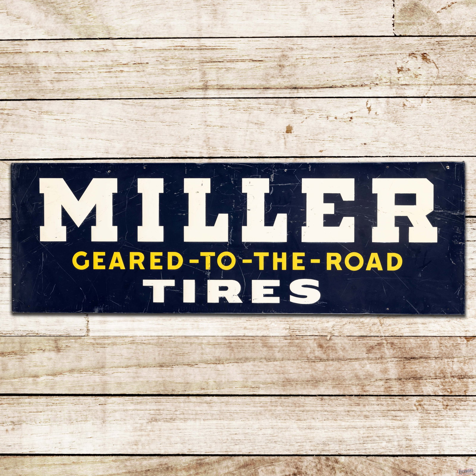 Miller Tires "Geared to the Road" 5' Emb. Single Sided Tin Sign: SST (single sided tin) embossed sign with the factory wooden support frame has good color and shine. The display has scratches with paint chips and small indentations. The perimeter has small added mo