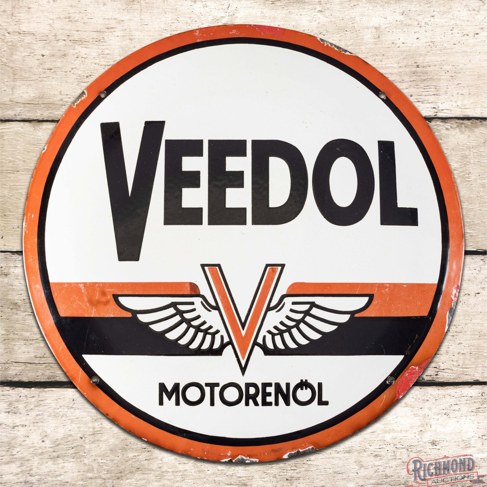 Veedol Motor Oil 19.5" Single Sided Porcelain Convex Sign: SSP (single sided porcelain) convex sign has good color and gloss. The field has light surface wear, discoloration to the red porcelain enamel, and the center portion of the sign is depressed lower th