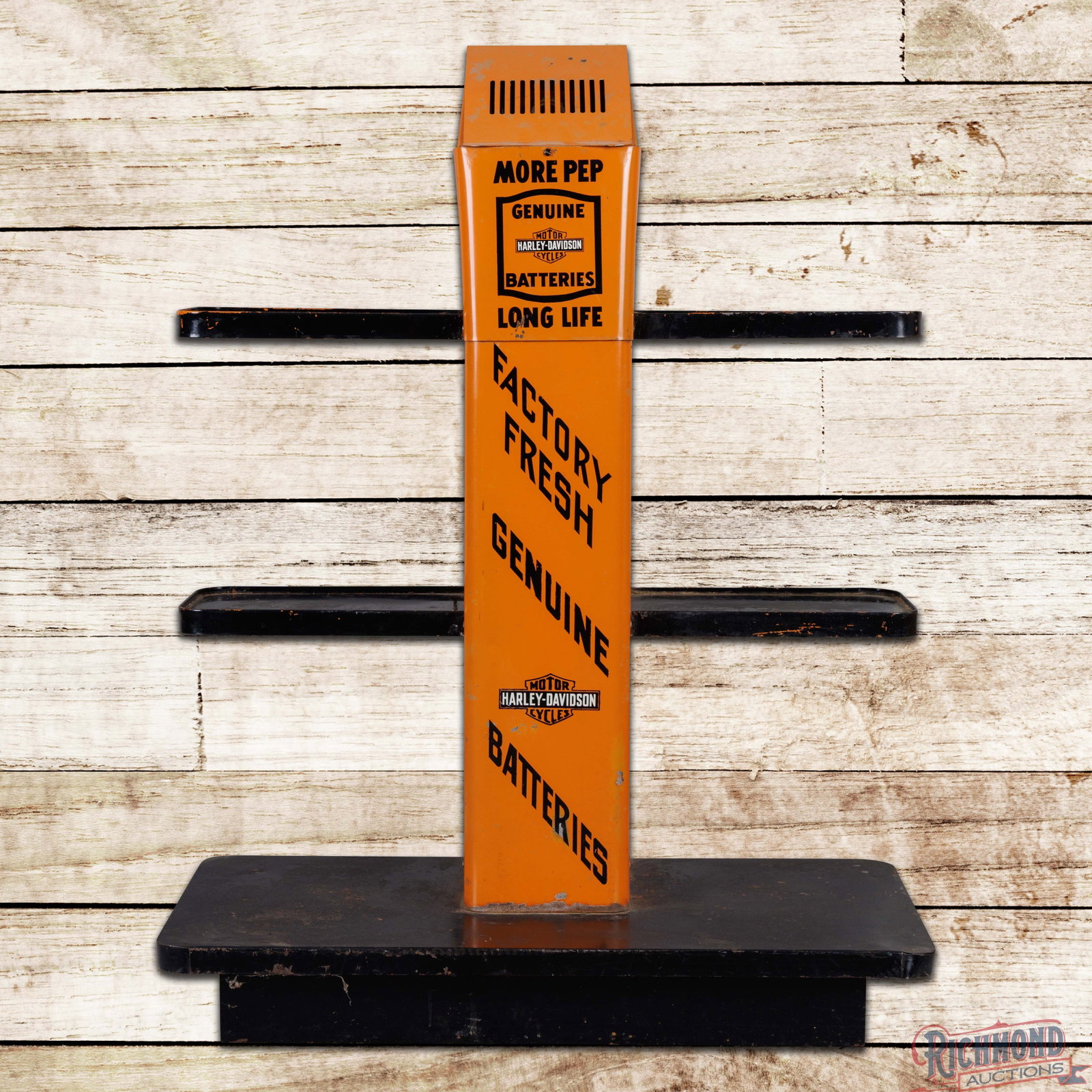 Harley Davidson Motorcycle Dealer Showroom Display Battery Charger w/ Logo: The display features vibrant factory paint with small scuffs, paint chips and minor dings in the fields. The racks have areas of paint loss with minor oxidation and edge bends. The upper portion of th