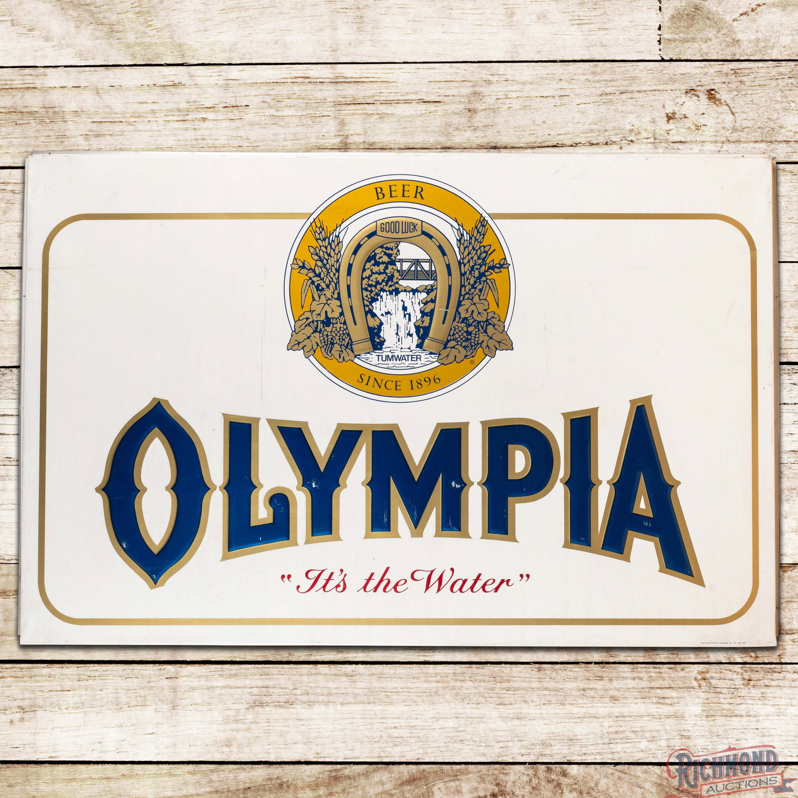 Olympia Beer "Since 1896 - It's The Water" 6' Emb. Double Sided Tin Sign w/ Logo: DST (double sided tin) embossed self-framed sign has excellent color and shine. Side #1 has rubs in the lettering with fine scratches and marks. The perimeter has bends and marks along the outer edges