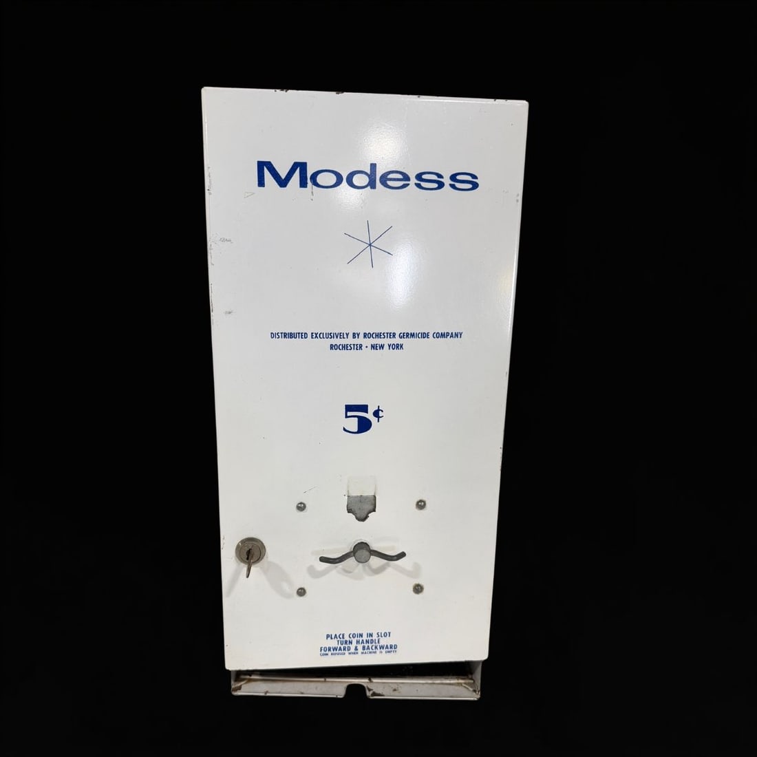 Modess 5C Tampon Dispenser Machine: Wear throughout. Untested. 18" H x 9" W x 7" D. All items are eligible for free delivery to Rustbelt Americana in East Moline, IL on 8/6-7 or other shows that Richmond Auctions attends. Size 18" H x