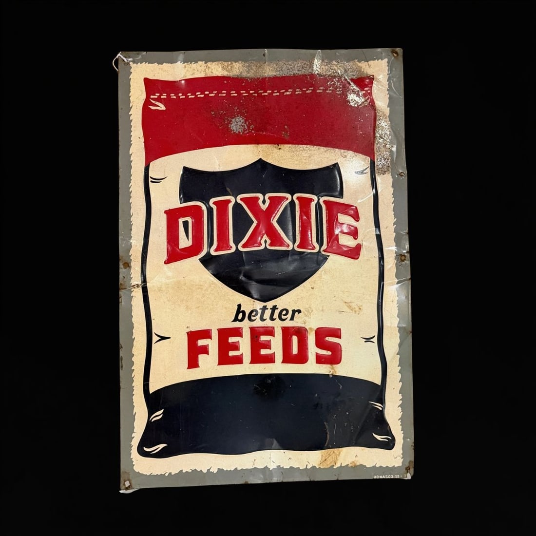 Dixie Better Feeds Tin Metal Sign.: Marked Donasco. Lots of bends, bumps and scrapes. 24" H x 16" W. All items are eligible for free delivery to Rustbelt Americana in East Moline, IL on 8/6-7 or other shows that Richmond Auctions