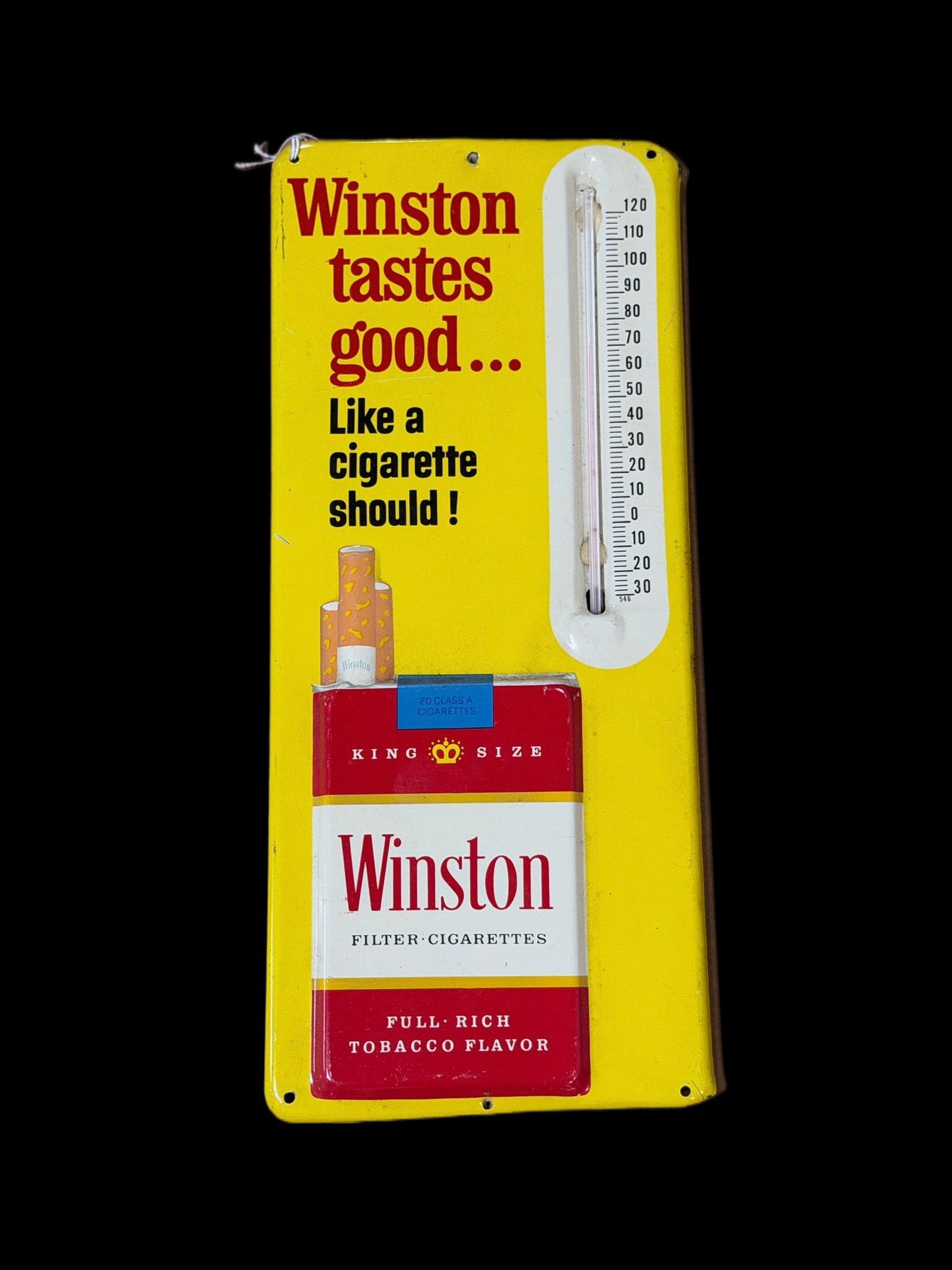 Winston Taste Good Cigarette Thermometer Sign: Light shelf wear. Has a dent under thermometer and at bottom. Thermometer works. 9" H x 14" W. All items are eligible for free delivery to Rustbelt Americana in East Moline, IL on 8/6-7 or other