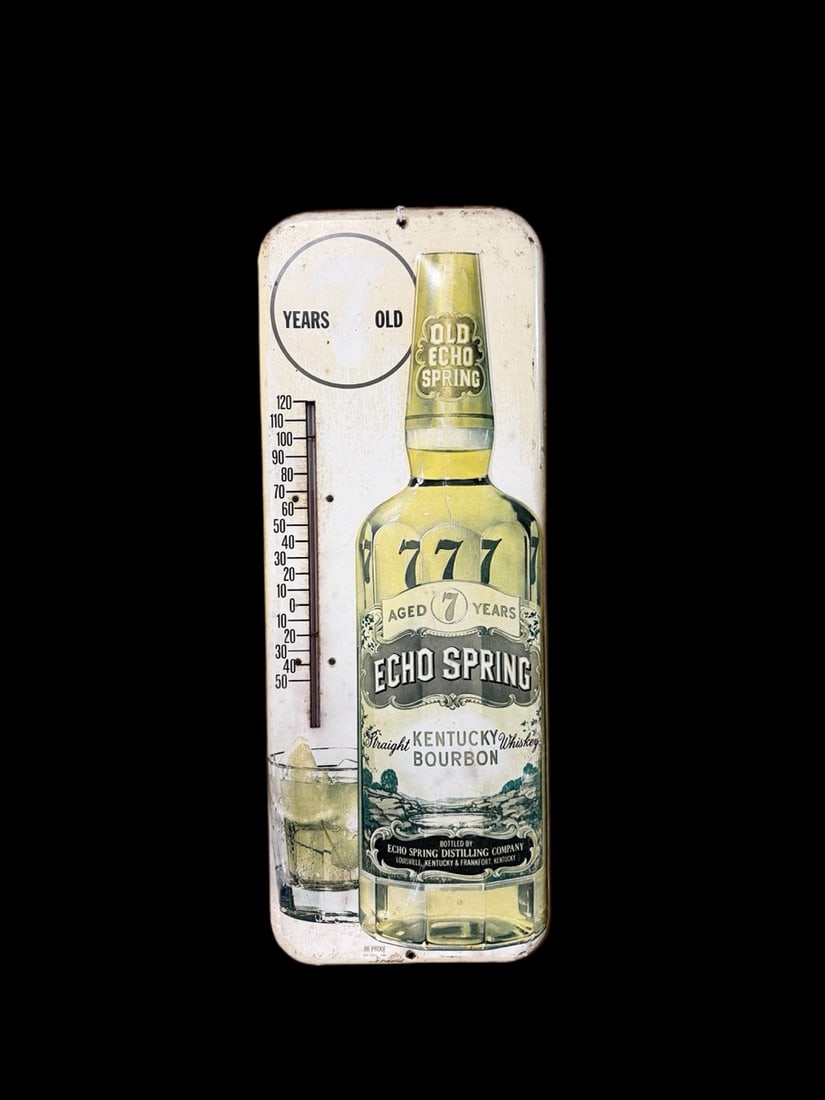 Echo Spring Kentucky Bourbon Embossed Thermometer: Marked ES-581. Fading and staining throughout. Scratches present throughout. Tube is present.. 26" H x 10" W. All items are eligible for free delivery to Rustbelt Americana in East Moline, IL on