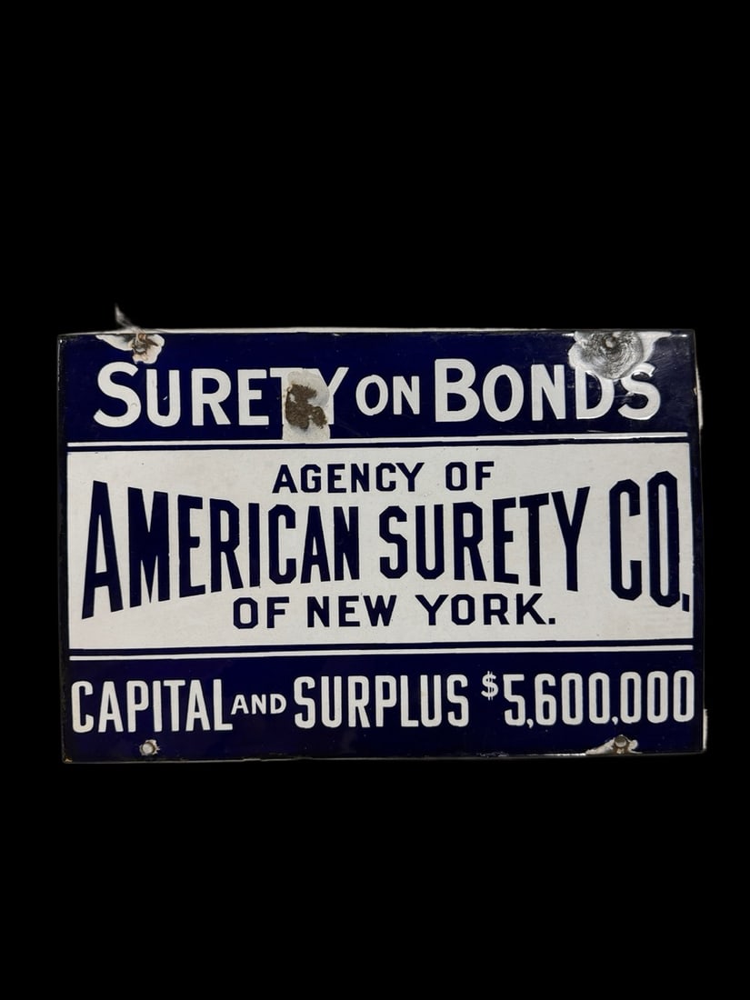 American Surety Co Porcelain Sign: Big chips around mounting holes and at the top. Light shelf wear otherwise. 10" H x 15" W. All items are eligible for free delivery to Rustbelt Americana in East Moline, IL on 8/6-7 or other shows