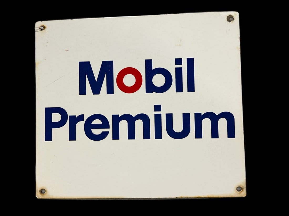 Mobil Premium Porcelain Sign: Discoloration along bottom and mounting holes. Light scratching in field. 12" H x 14" W. All items are eligible for free delivery to Rustbelt Americana in East Moline, IL on 8/6-7 or other shows that 