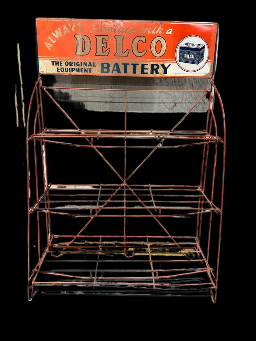 Delco Battery Original Battery Display: Rust on the topper, rack is complete. 50" H x 34" W. All items are eligible for free delivery to Rustbelt Americana in East Moline, IL on 8/6-7 or other shows that Richmond Auctions attends. Size 50"