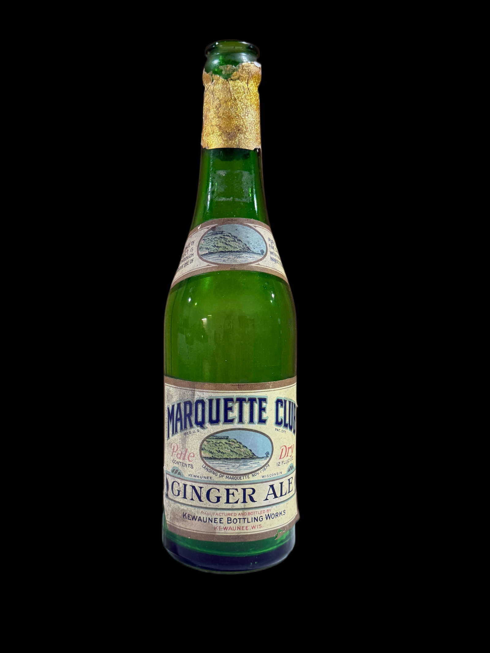 Marquette Club Ginger Ale Bottle: Bottom left of front label is missing. Has typical wear for a bottle of this age. 10" H x 3" W. All items are eligible for free delivery to Rustbelt Americana in East Moline, IL on 8/6-7 or other
