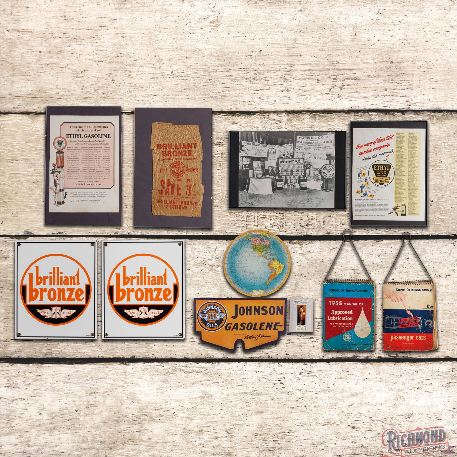 Group of 11 Johnson Oil Refining Co. Advertisement & Signs: Group of eleven Johnson Oil items includes two reproduction porcelain pump plates dated 6/99, framed ads, a postcard, a reproduction cardboard winterfront, lubricant charts and a cardboard complimenta