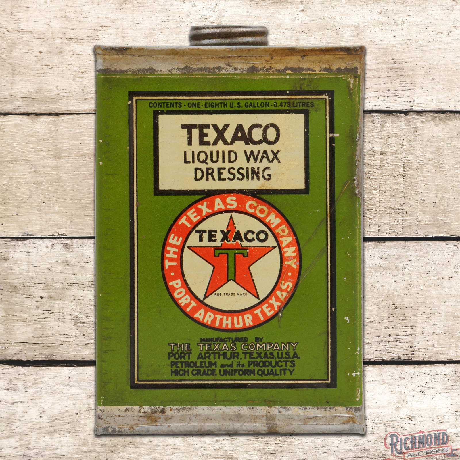 Texaco Liquid Dressing Wax Empty 1 Pint Motor Oil Can: Empty metal one-pint can with cap has good color and shine. The display has tiny paint chips in the fields with light wear and a minor indentation along the upper edge. The reverse is in a similar con