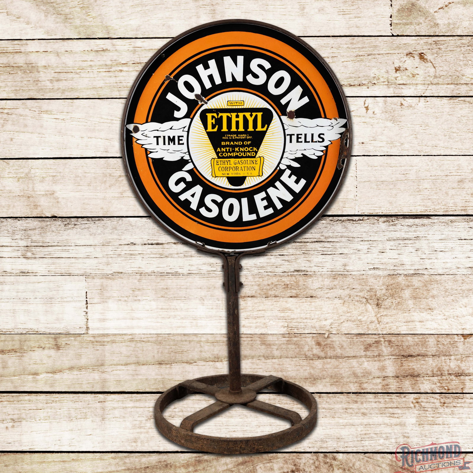 Johnson Time Tells Ethyl Gasolene 30" DSP Curb Sign w/ Base: DSP sign with the original ring, pole and strap base has very good color and gloss. The display field has chips with minor areas of discoloration. The perimeter has a slight vertical bend along the ri