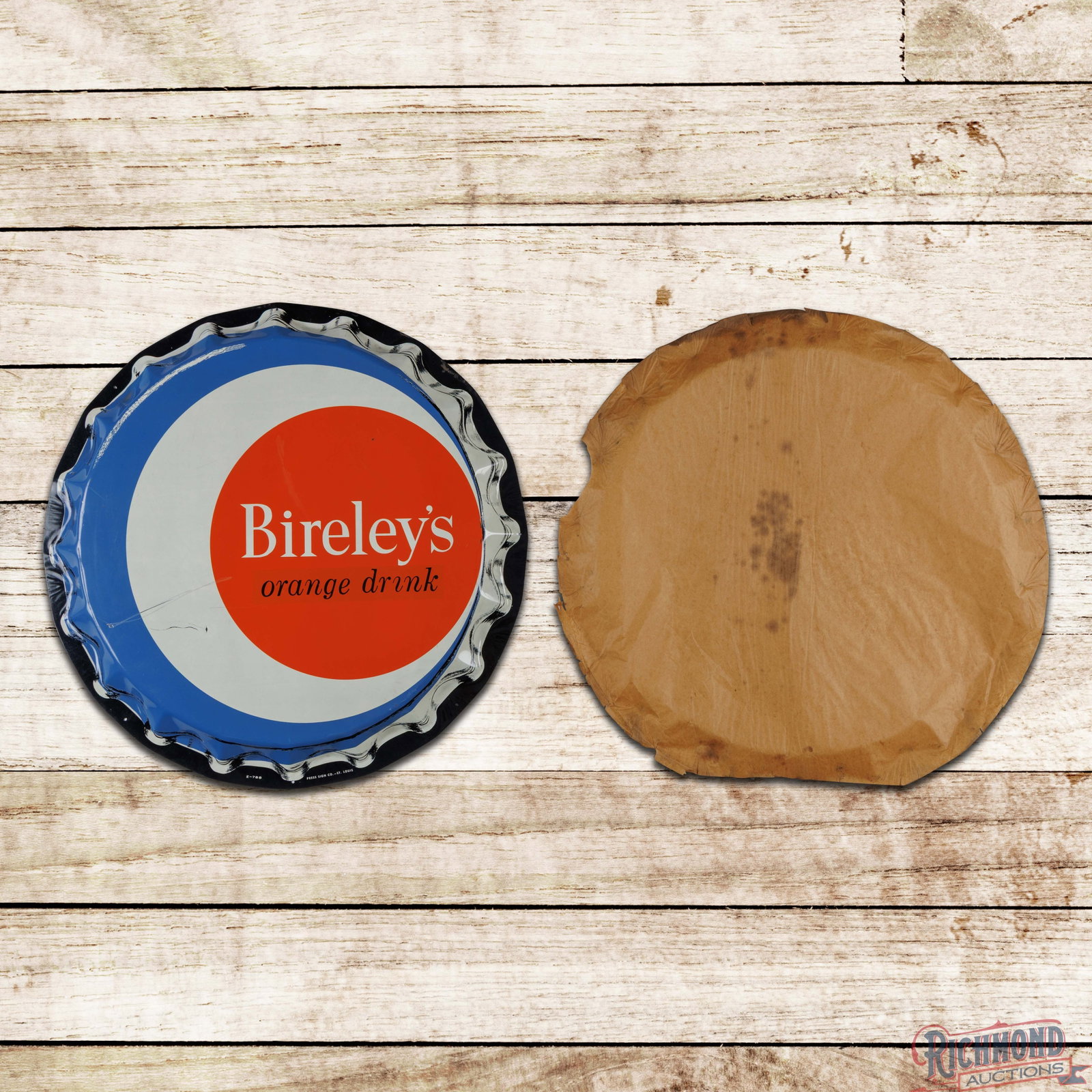 NOS Bireley's Orange Drink 29" SST Convex Bottlecap Sign: SST convex sign with the factory paper has excellent color and shine. The display has scratches with small indentations in the left field and other areas of light wear and discoloration. Marked E-788 