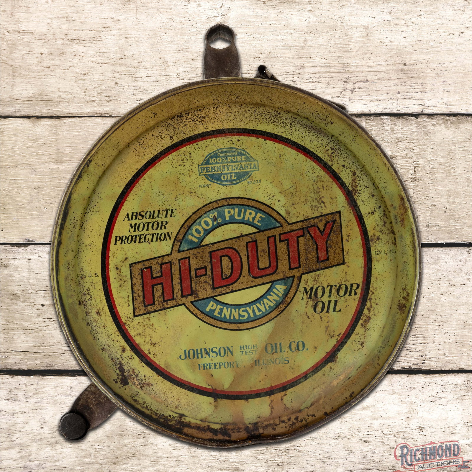 Johnson Oil Co Hi-Duty Motor Oil Metal Rocker Can w/ Logo: Empty five-gallon rocker can retains the original cap and handle. Side #1 presents with oxidation, paint chips and discoloration. The reverse has numerous paint chips with oxidation. The can displays 