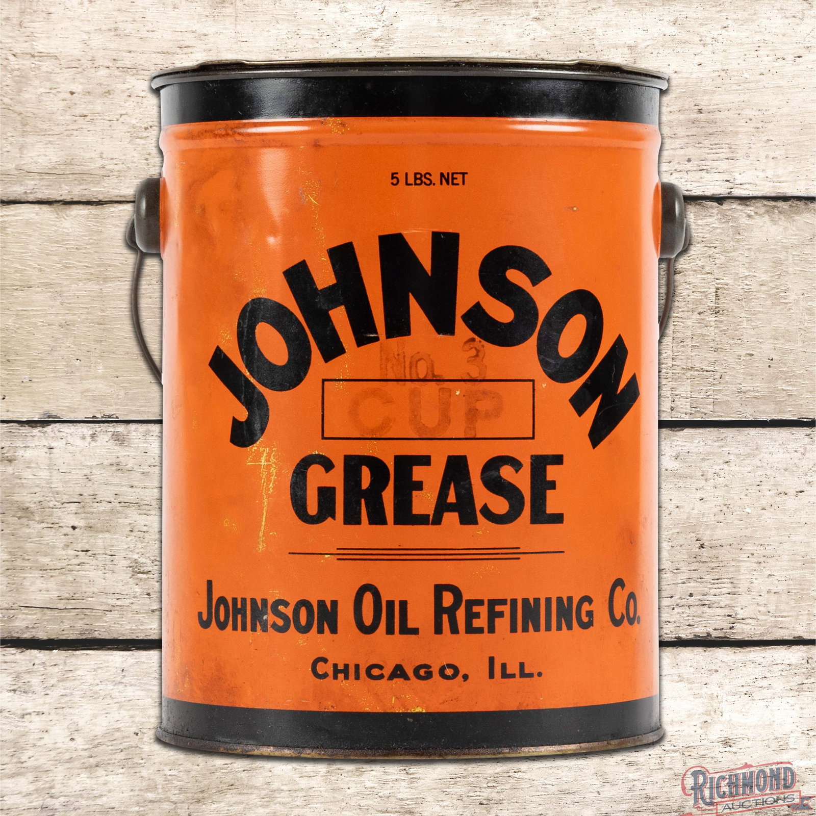 Johnson Oil Refining Co. 5 Pound Metal Grease Can FULL: Full metal five-pound grease can with the original handle and lid has very good color and shine. The display side has a tiny indentation in the logo, small paint chips in the left fields, and areas of