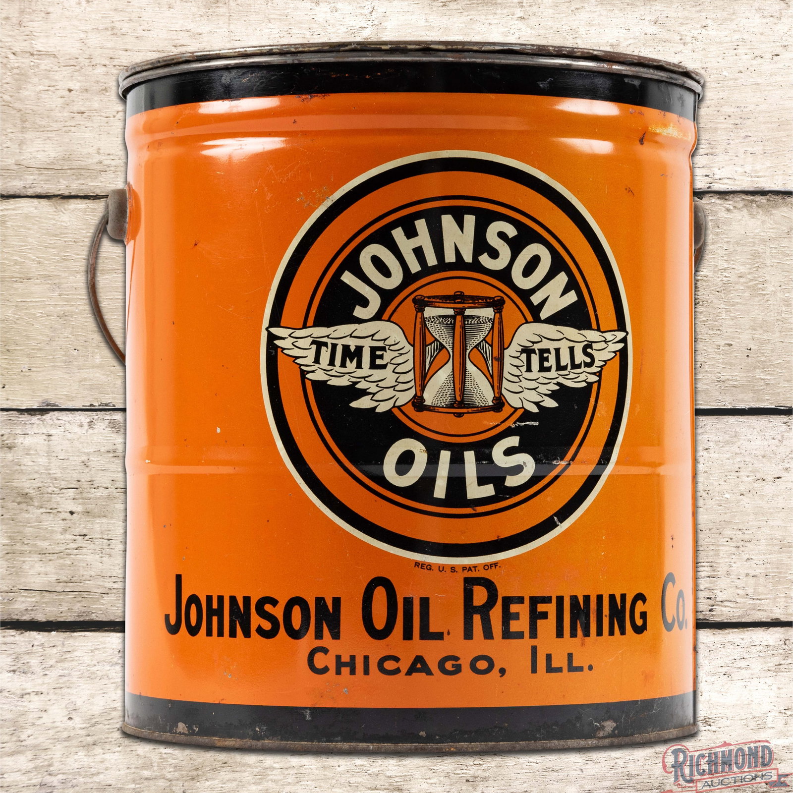 Johnson Oil Refining Co. 25 Pound Empty Metal Grease Can: Empty 25 pound metal can with the original handle and lid has very good color and shine. The display has small scratches with light wear and areas of minor discoloration. The reverse has additional we