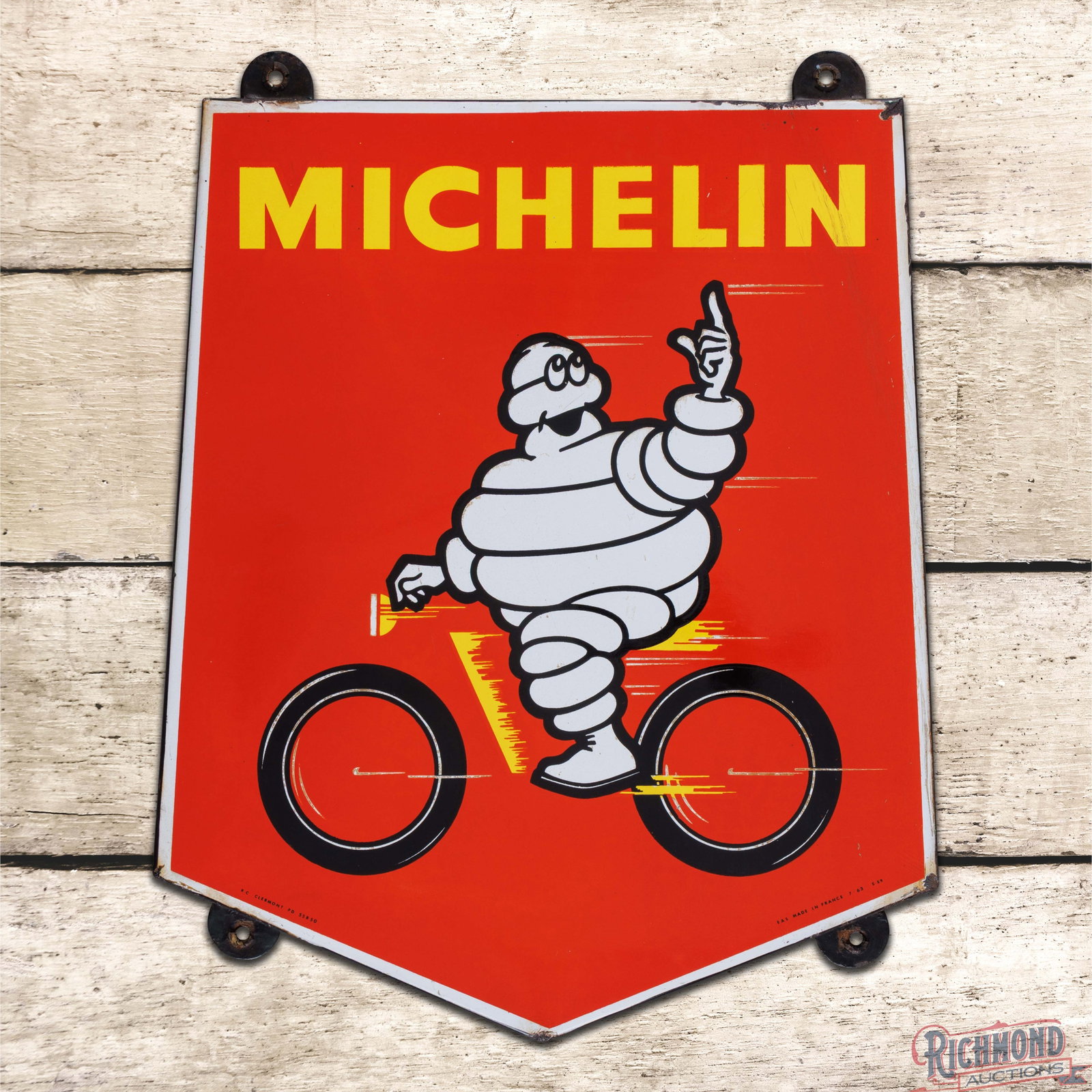 Michelin Bicycle Tires SSP Die Cut Sign w/ Bibendum: SSP rolled-edge sign has excellent color and gloss. The display is very clean overall with light wear and slight discoloration in the lower white speed lines. The upper right outer field has crazing t