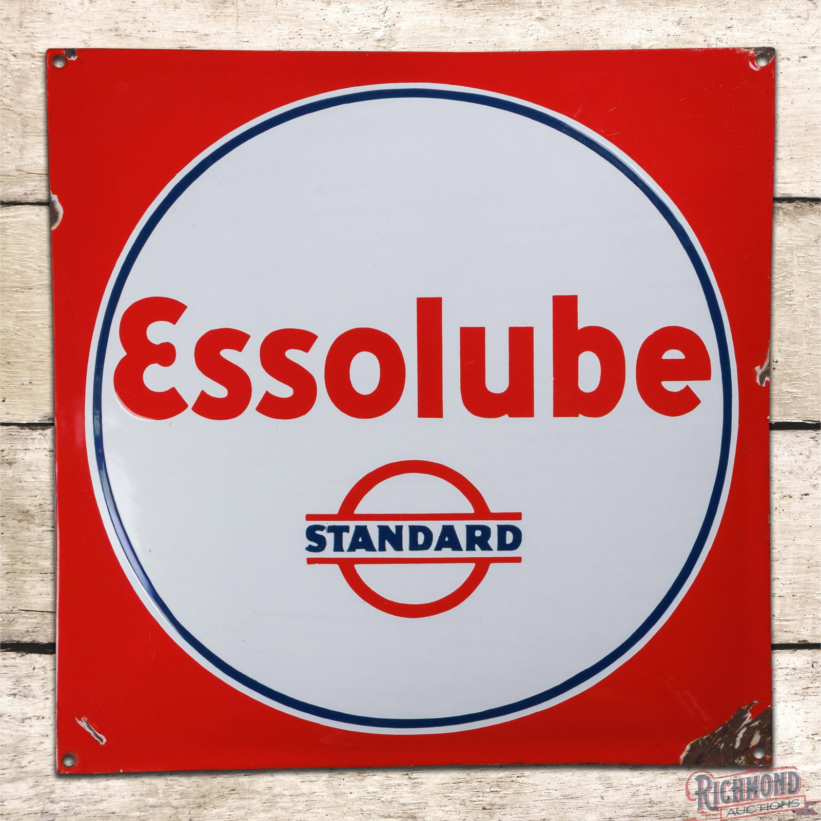 Standard Essolube 21.5" SSP Pillow Sign w/ Logo: SSP convex pillow sign has excellent color and gloss. The fields are clean with minor surface wear to the lettering. The perimeter has chips at the mounting holes and the outer edges. The sign has a g