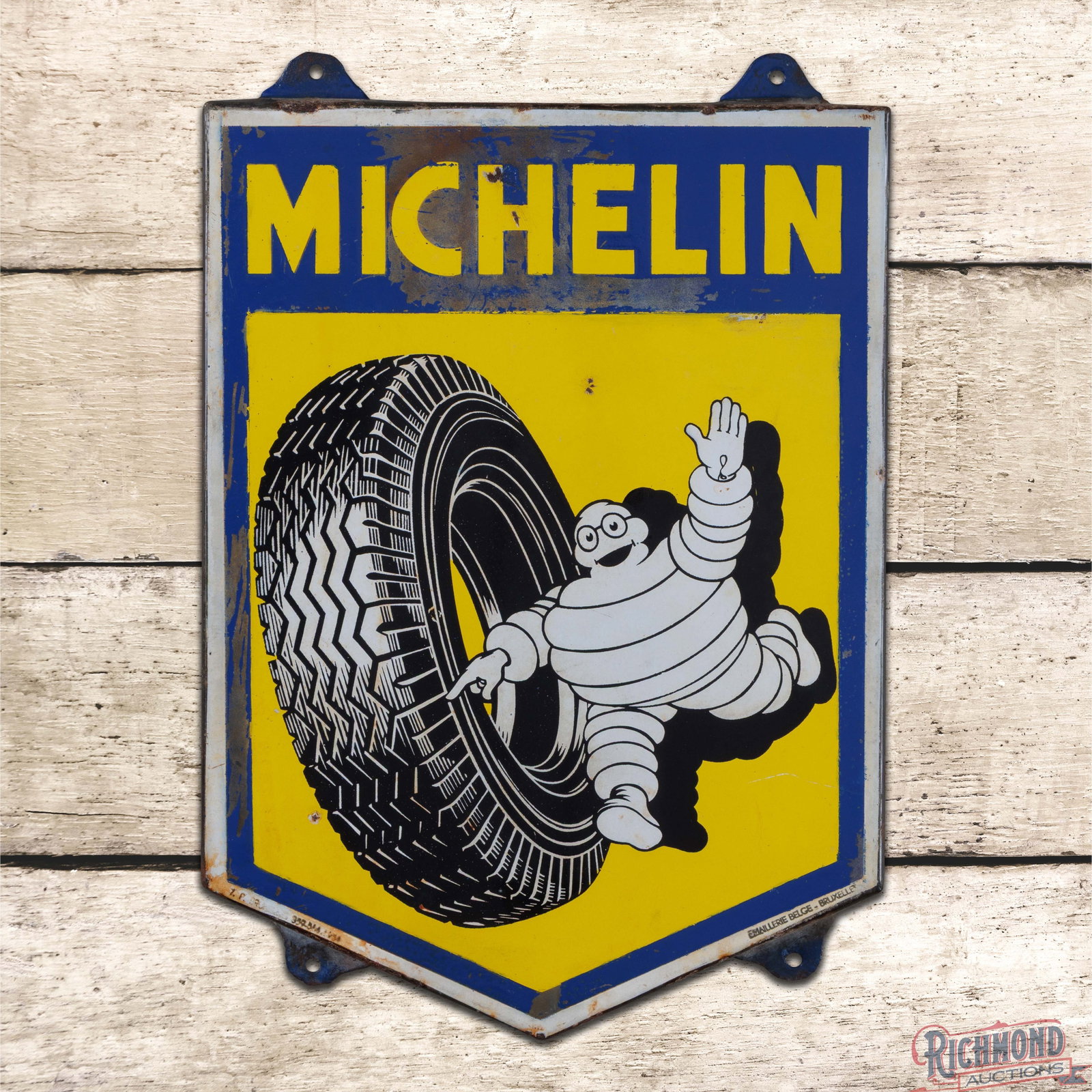 Michelin Truck Tires Die Cut SSP Sign w/ Bibendum: SSP rolled-edge sign has good color. The fields have discoloration with areas of lower gloss and small chips. The upper lettering and perimeter have low gloss with etched porcelain and discoloration. 
