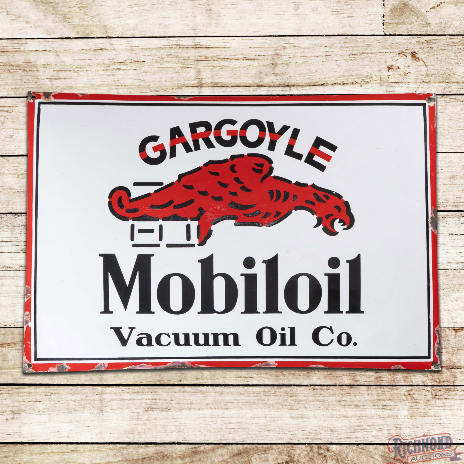 Gargoyle Mobiloil Vacuum Oil Co. 30" SSP Convex Sign: SSP pillow sign has excellent color and gloss. The display has light wear with fine scratches and small bruises in the center field. The perimeter has chips along the outer edges. The sign features he