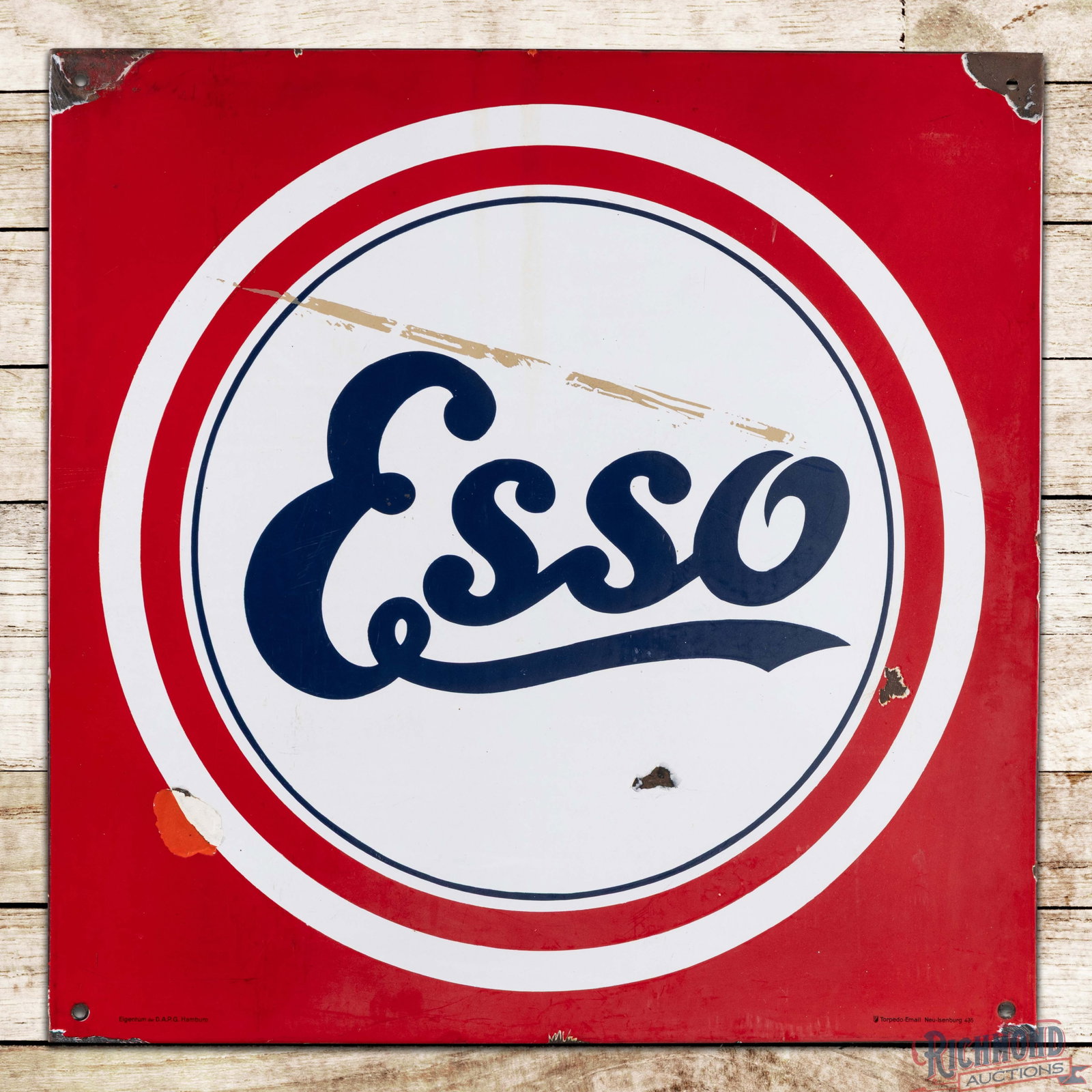 Esso Motor Oils 31" SSP Sign w/ Logo: SSP rolled-edge sign has very good color and gloss. The field has light wear and minor discoloration. The lower portion of the logo has three chips with an area of color match on the lower left edge. 