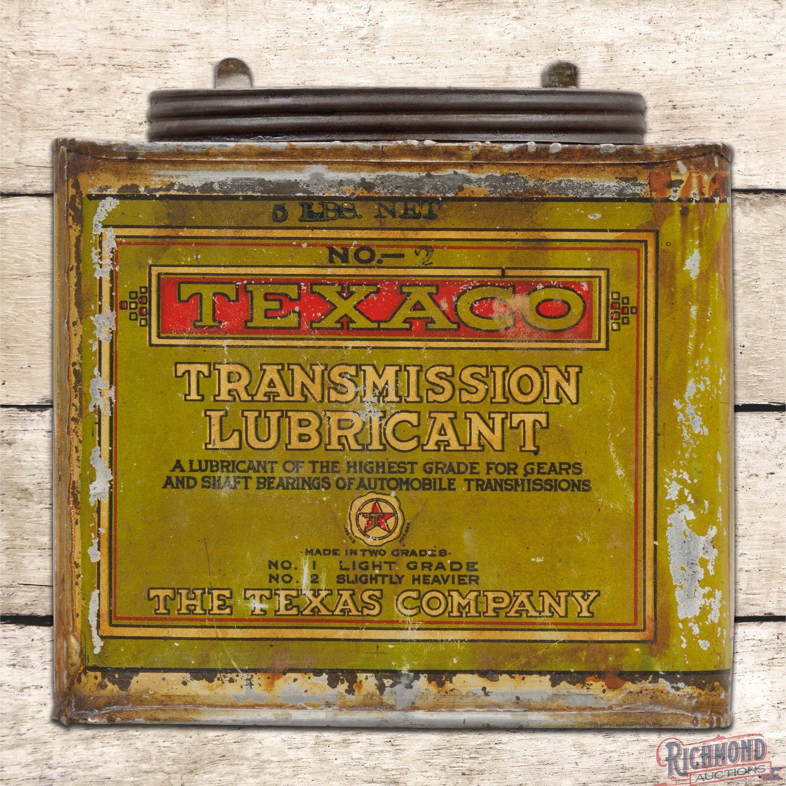 Early Texaco Transmission Lubricant Empty 5 Pound Metal Can: Empty five pound metal can with the original lid has good color and shine. The display has toning with paint chips and discoloration. The side with the Texaco logo has larger paint chips present. The 