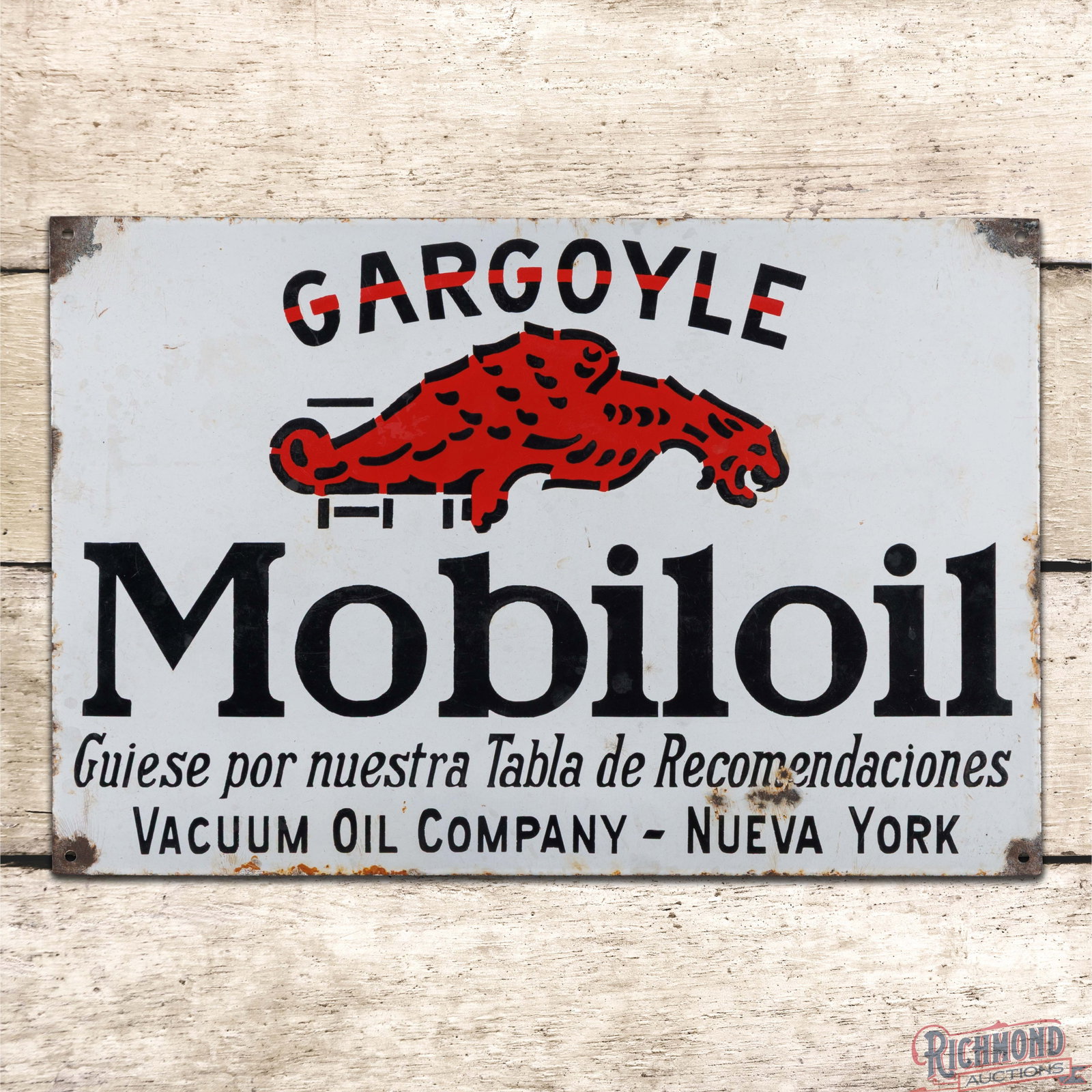 Gargoyle Mobiloil Vacuum Oil Company Nueva York 24" SSP Convex Sign: SSP pillow sign has good color and gloss. The display has surface wear with fine scratches, chips in the lower fields and areas of cloudiness throughout. The perimeter has chips with minor crazing, sm