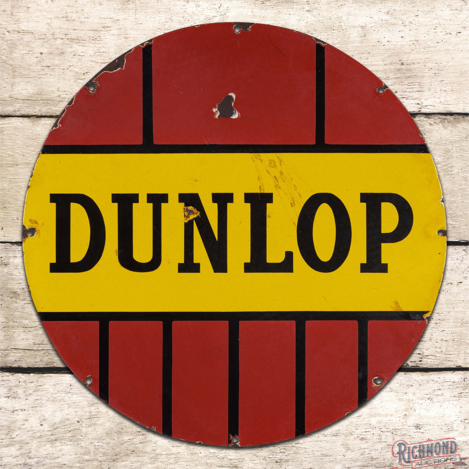 Dunlop Tires 23.5" DSP Sign: DSP sign has good color and gloss. The display has chips with crazing. The outer fields and perimeter have areas of minor discoloration and additional chips. The reverse has factory blemishes in the y