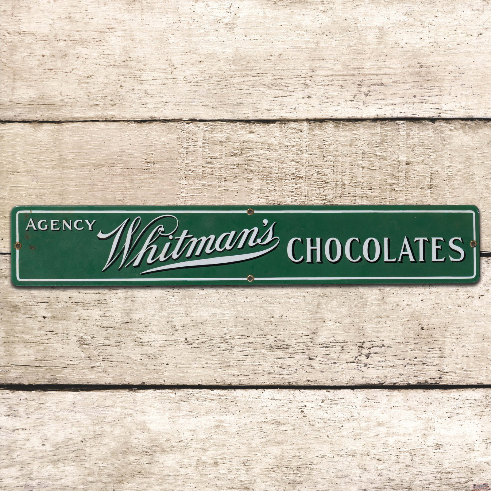 Whitman's Chocolates Agency 24" SSP Sign: Amazing SSP sign has day one color and gloss. The field is clean. The perimeter has a tiny chip on the upper right edge. All four factory grommets are present. Overall a fantastic example with brillia