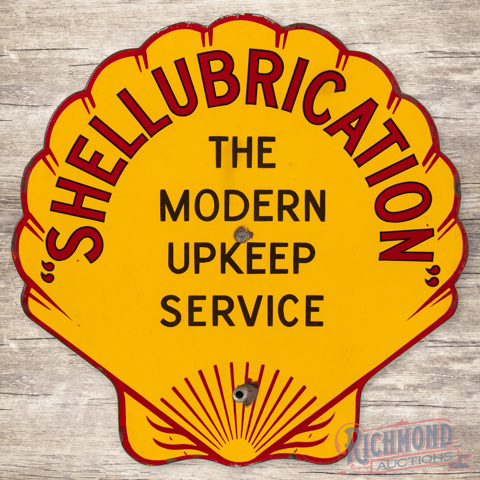 Rare Shell Shellubrication "The Modern Upkeep Service" Single Sided Porcelain Logo Sign: SSP (single sided porcelain) die cut sign has excellent color and gloss. The display has minor discoloration in the upper field with a tiny chip at the center mounting hole and larger chip at the lowe
