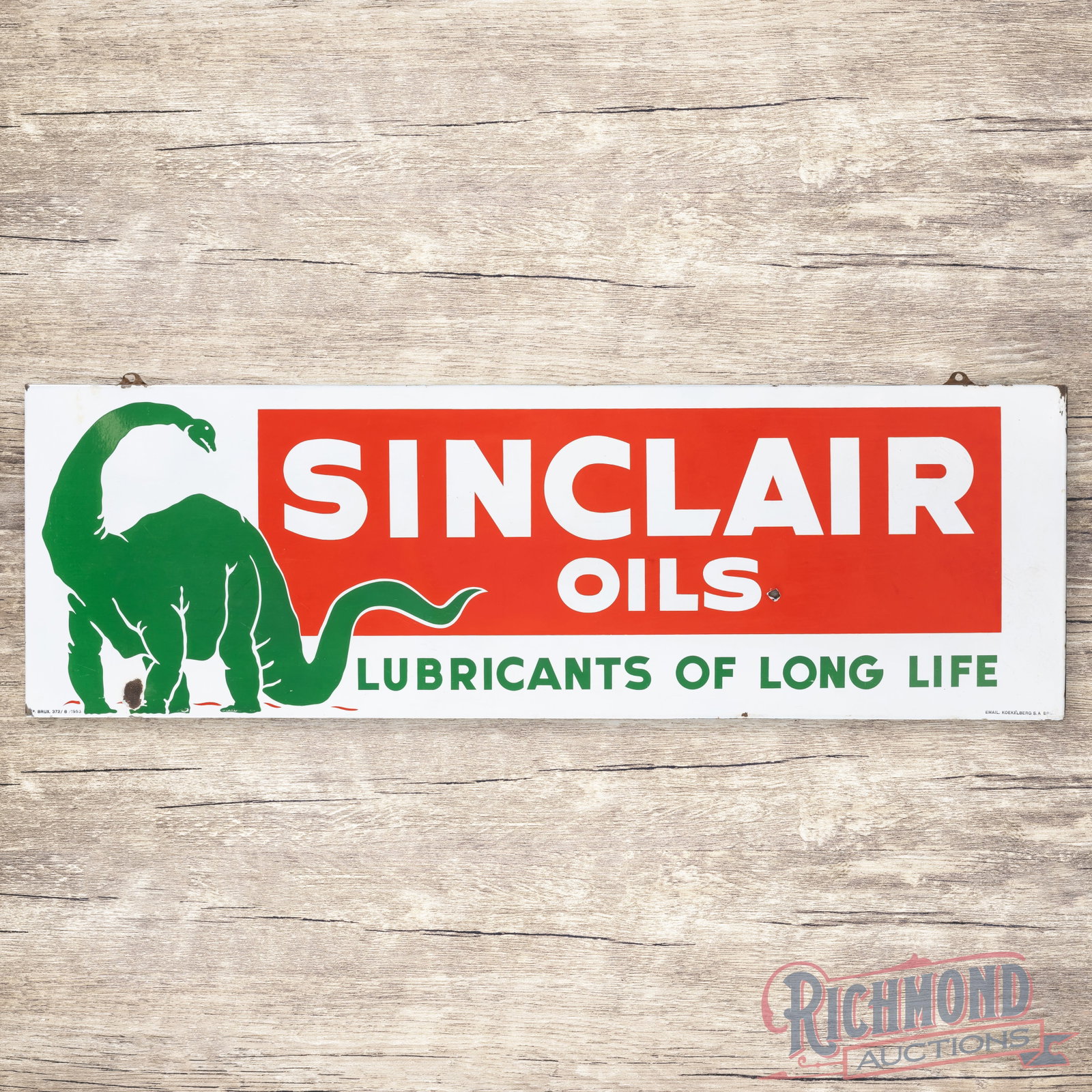 1953 Sinclair Lubricants of Long Life 5' Single Sided Porcelain Sign w/ Standing Dino: SSP (single sided porcelain) rolled-edge sign has excellent color and gloss. The field has some surface wear in the lettering and a chip by the "S" in Oils. The perimeter has a larger chip by Dino's f