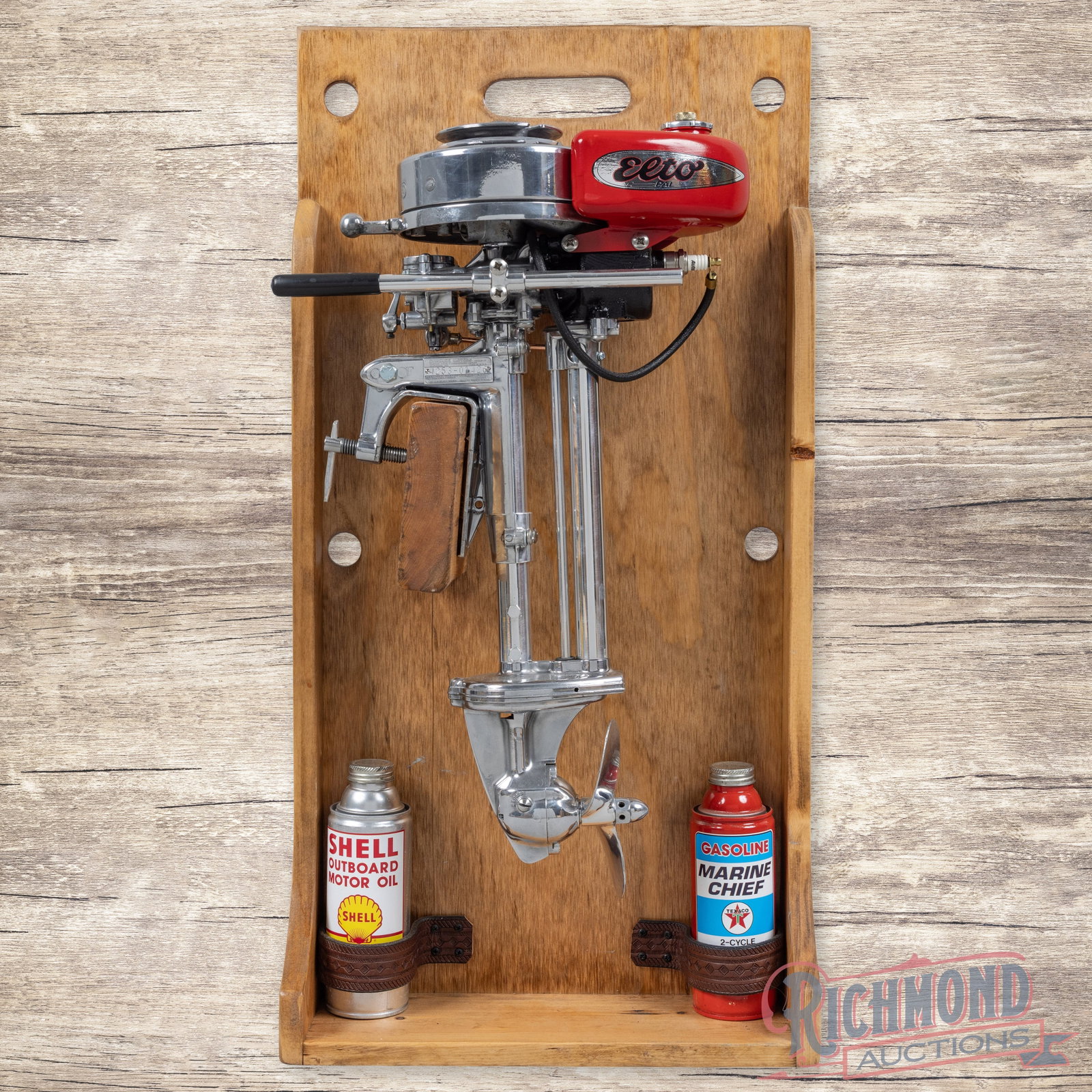 Restored Evinrude Elto Pal Outboard Motor Display: Elto Pal engine has been professionally restored and mounted to a custom wood display. The display is clean and features a propeller with custom Shell and Texaco Outboard Motor Oil cans. All in all a 