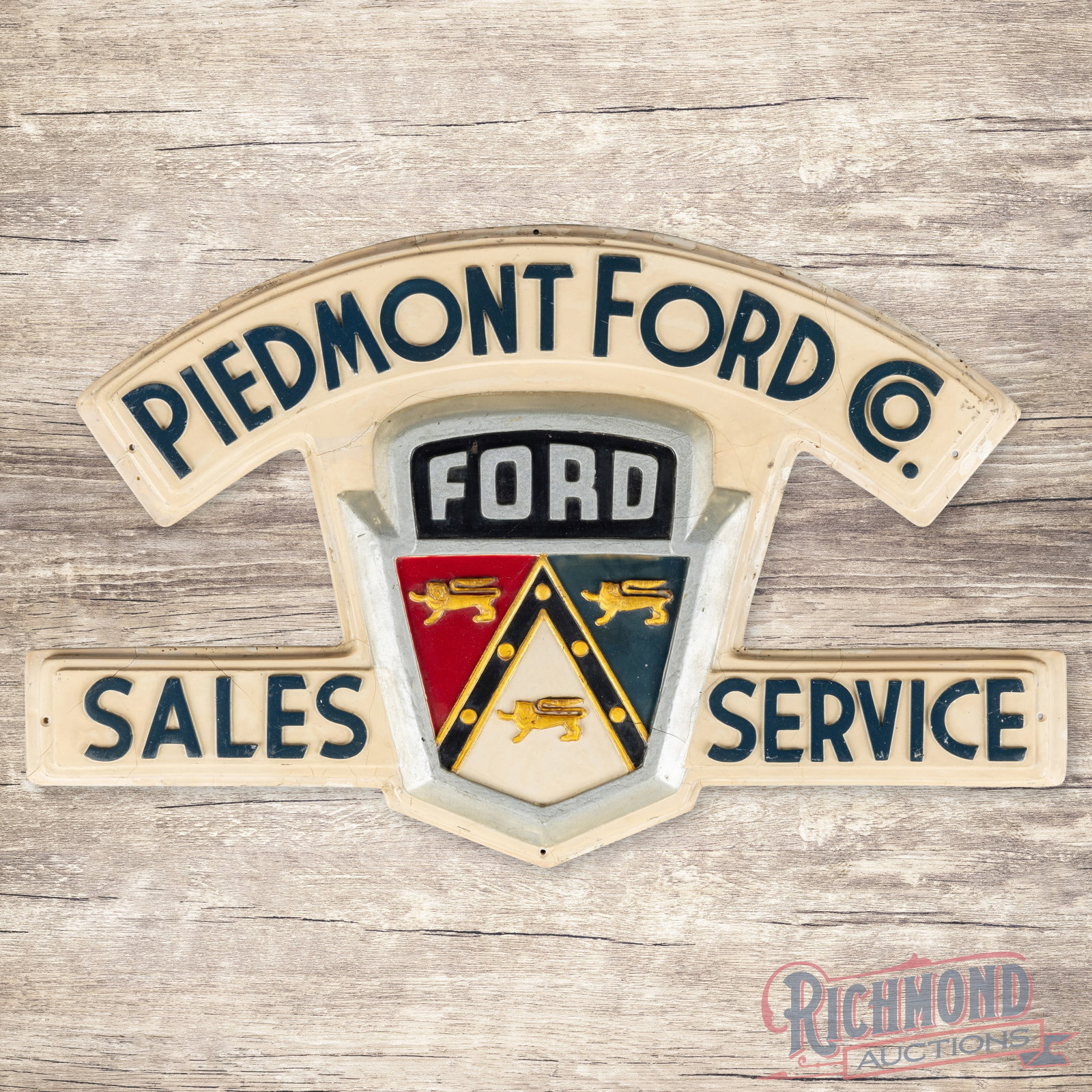 Piedmont Ford Co. Sales Service Emb. Sign w/ Crest Logo: Single sided embossed die cut fiberglass sign has good color and shine. The sign features a heavily embossed crest logo and lettering. The sign has areas of color match, age-related cracks and paint c