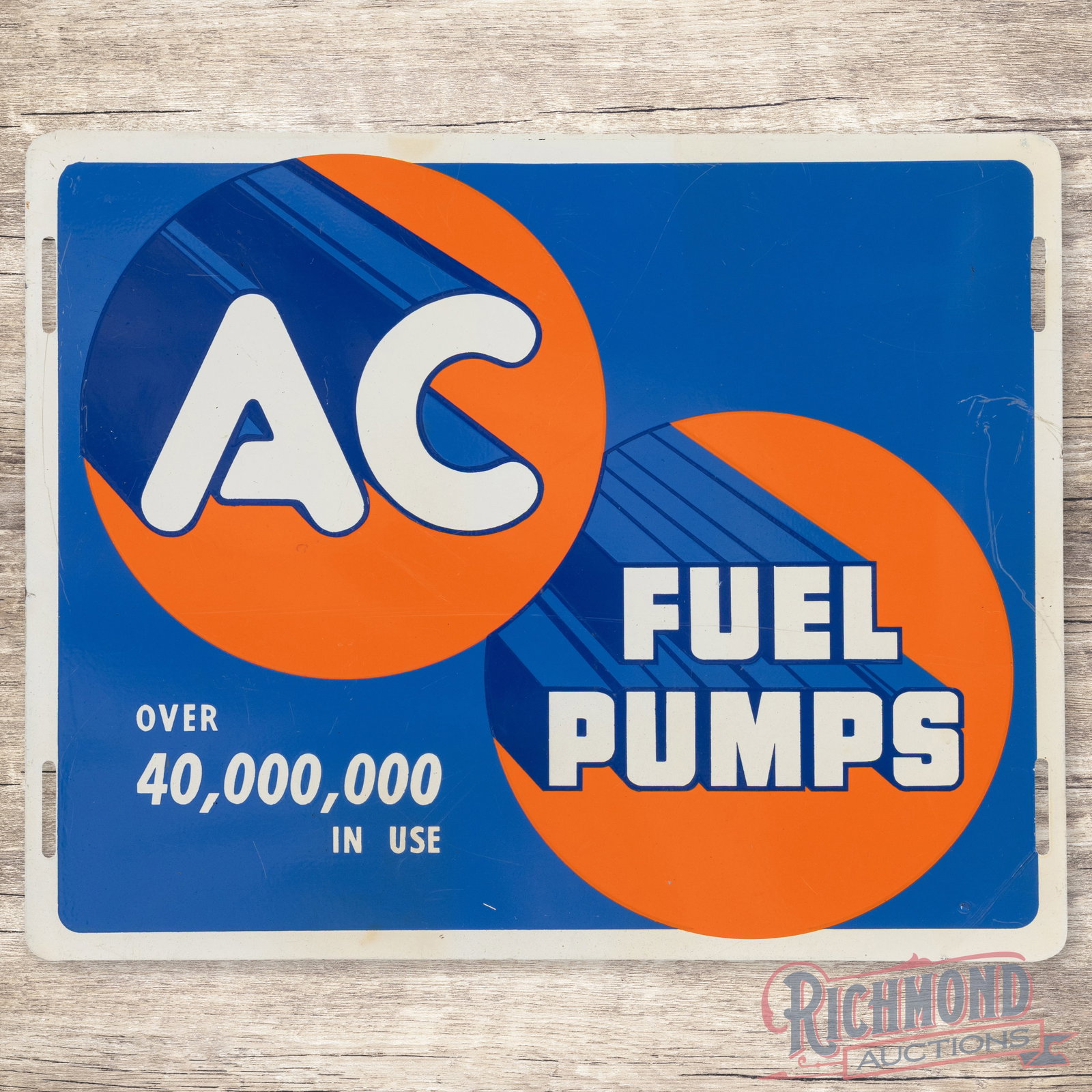 AC Fuel Pumps "Over 40,000,000 in Use" Single Sided Tin Sign: SST (single sided tin) sign has excellent color and shine. The display has light wear with faint paper marks and fine scratches. The perimeter has rubs with a scratch along the right hand side with sm