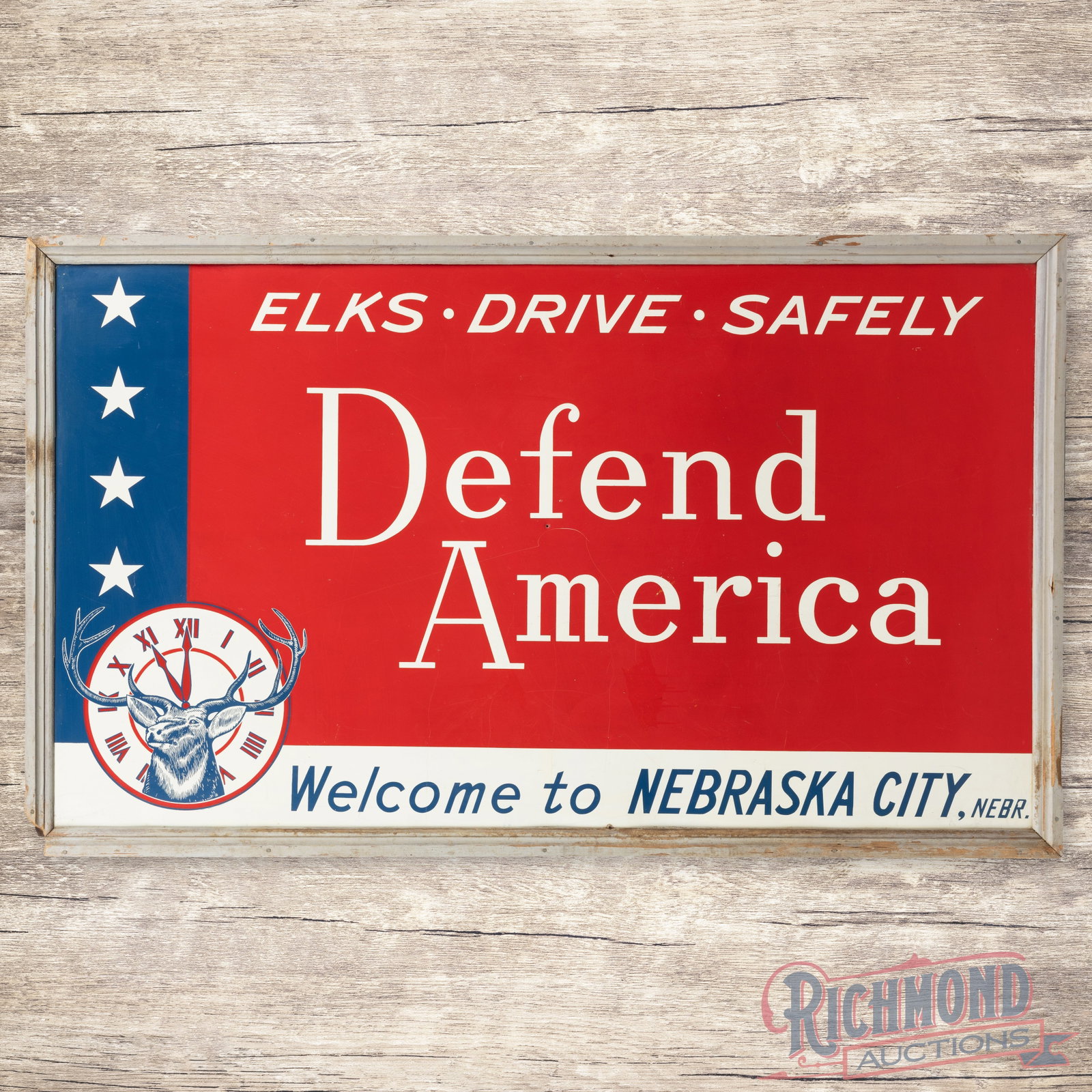 Elks Drive Safely Defend America Welcome to Nebraska City 5' Single Sided Tin Sign w/ Logo: SST (single sided tin) sign with the factory wooden frame has excellent color and shine. The field has a small, unused mount hole in the center, a scratch below the "F" in Defend and other light wear.